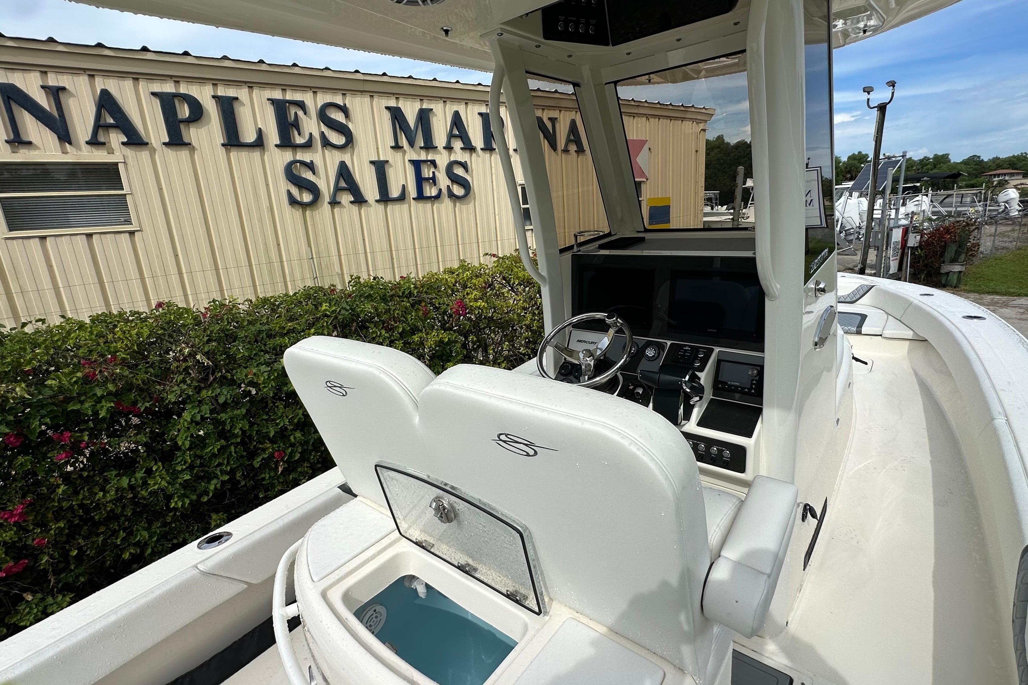 2026 ShearWater 270 SS Open boat at Naples Marina Sales, showcasing helm and seating area.