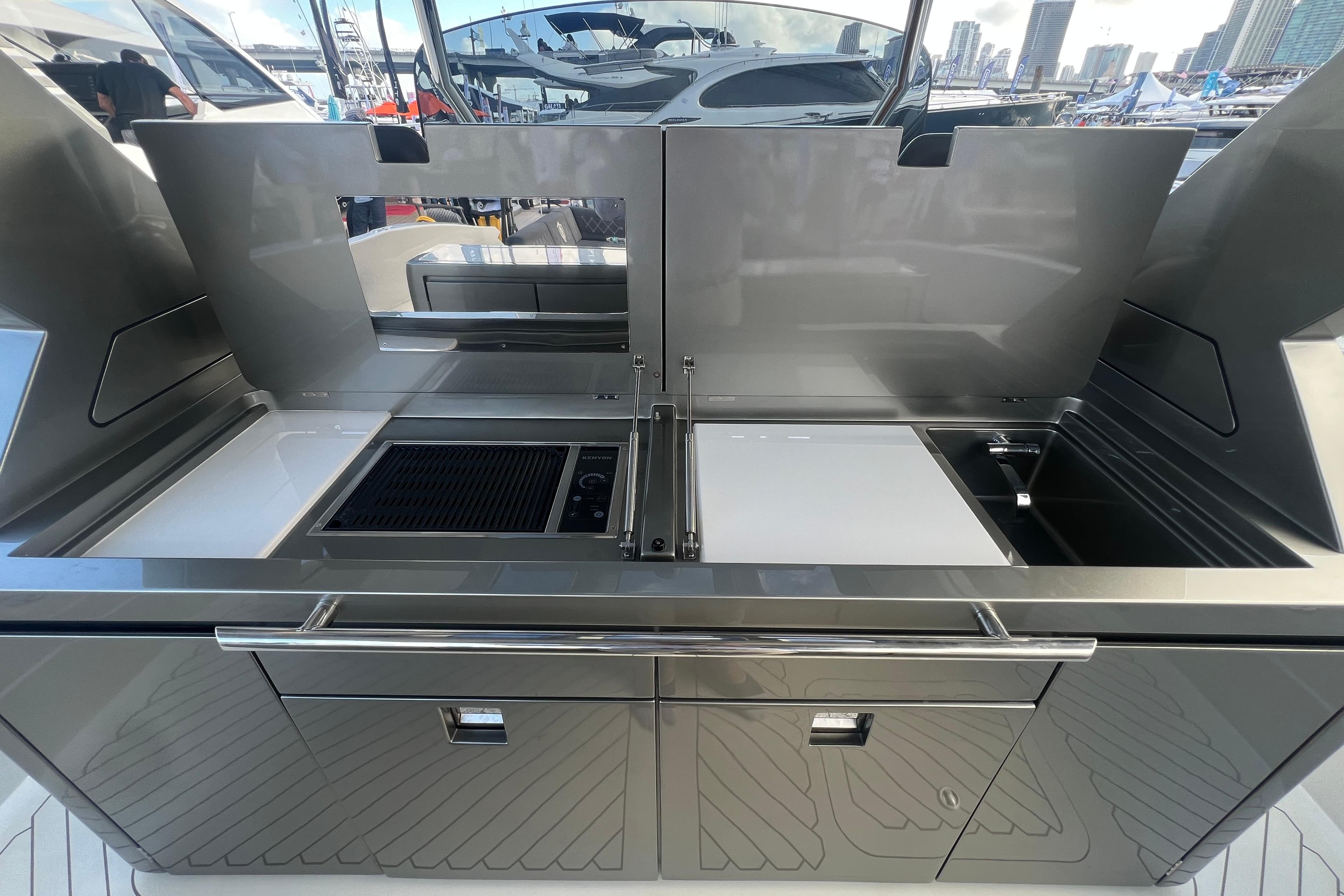 Outdoor kitchen on 2023 Canados 493 Gladiator yacht, featuring grill and sink.