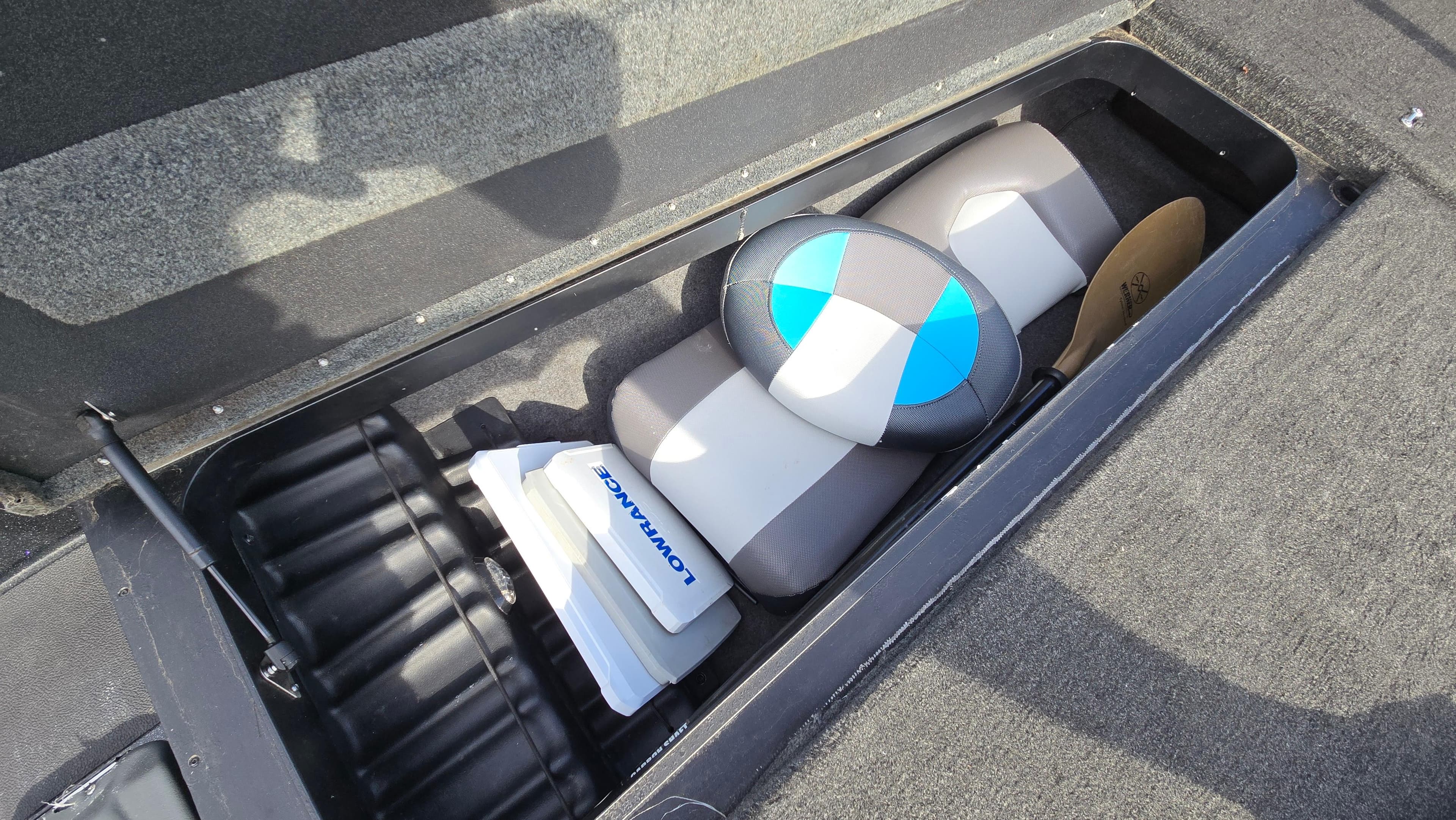 Storage compartment in a 2017 Skeeter ZX 250 boat with equipment and accessories.