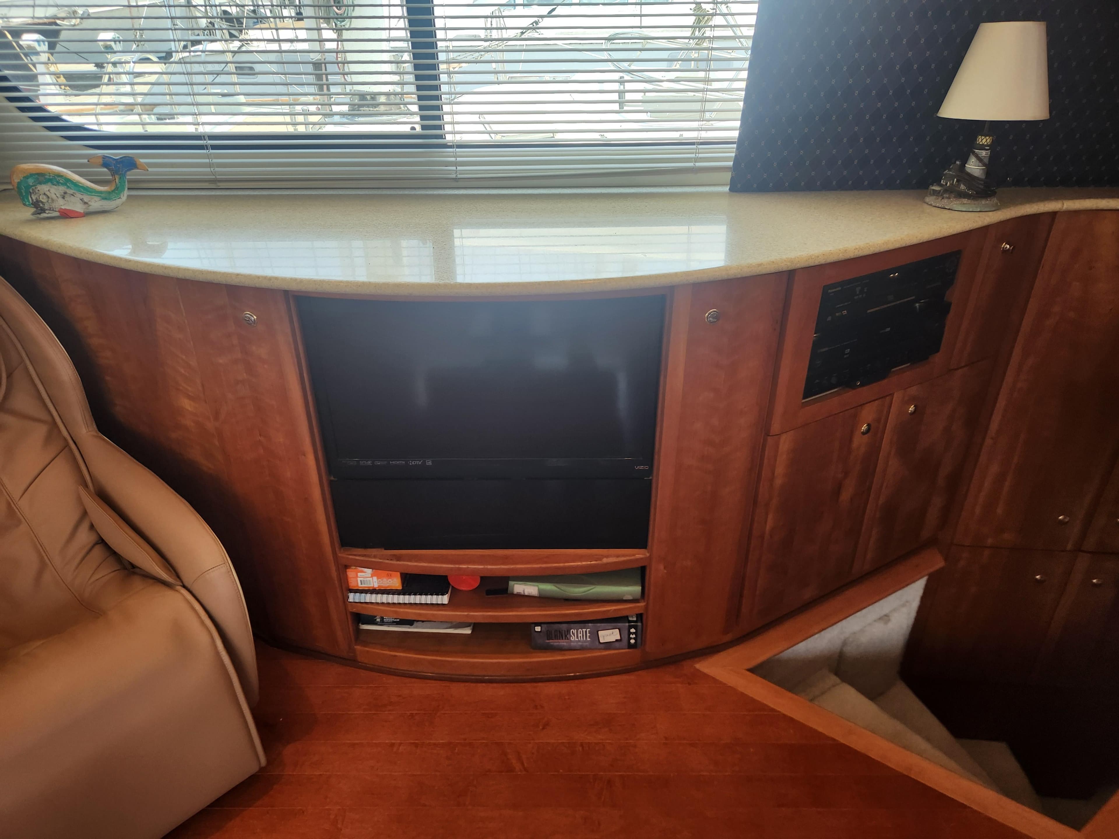 Interior of 2000 Silverton 453 Motor Yacht with TV, shelves, and lamp.
