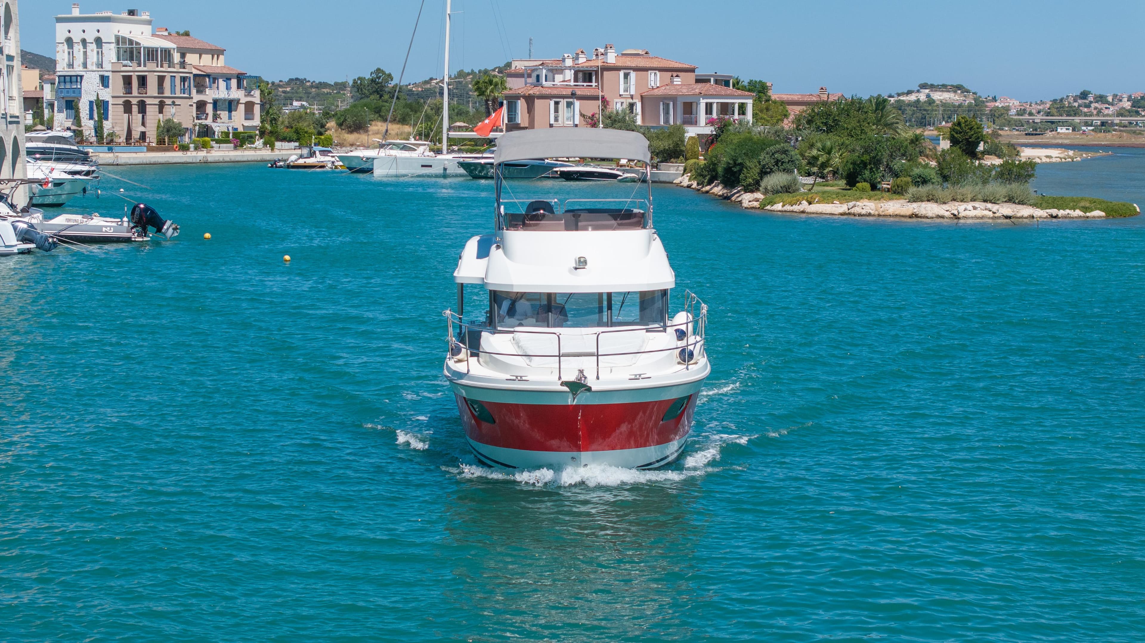 2022 Beneteau Swift Trawler 35 cruising in a scenic coastal area.