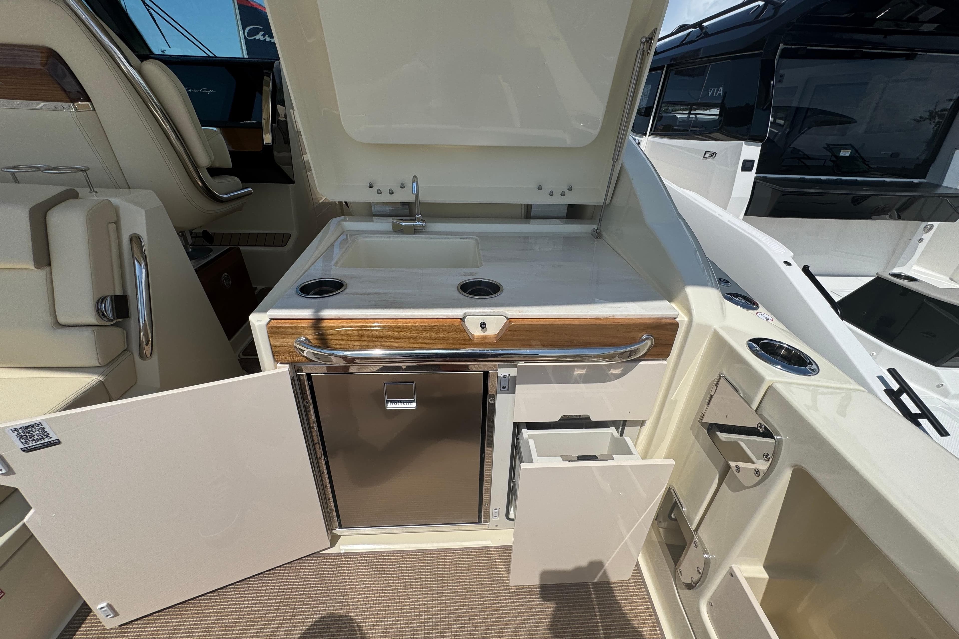 2026 Chris-Craft Calypso 32 boat interior with kitchenette, sink, and storage compartments.