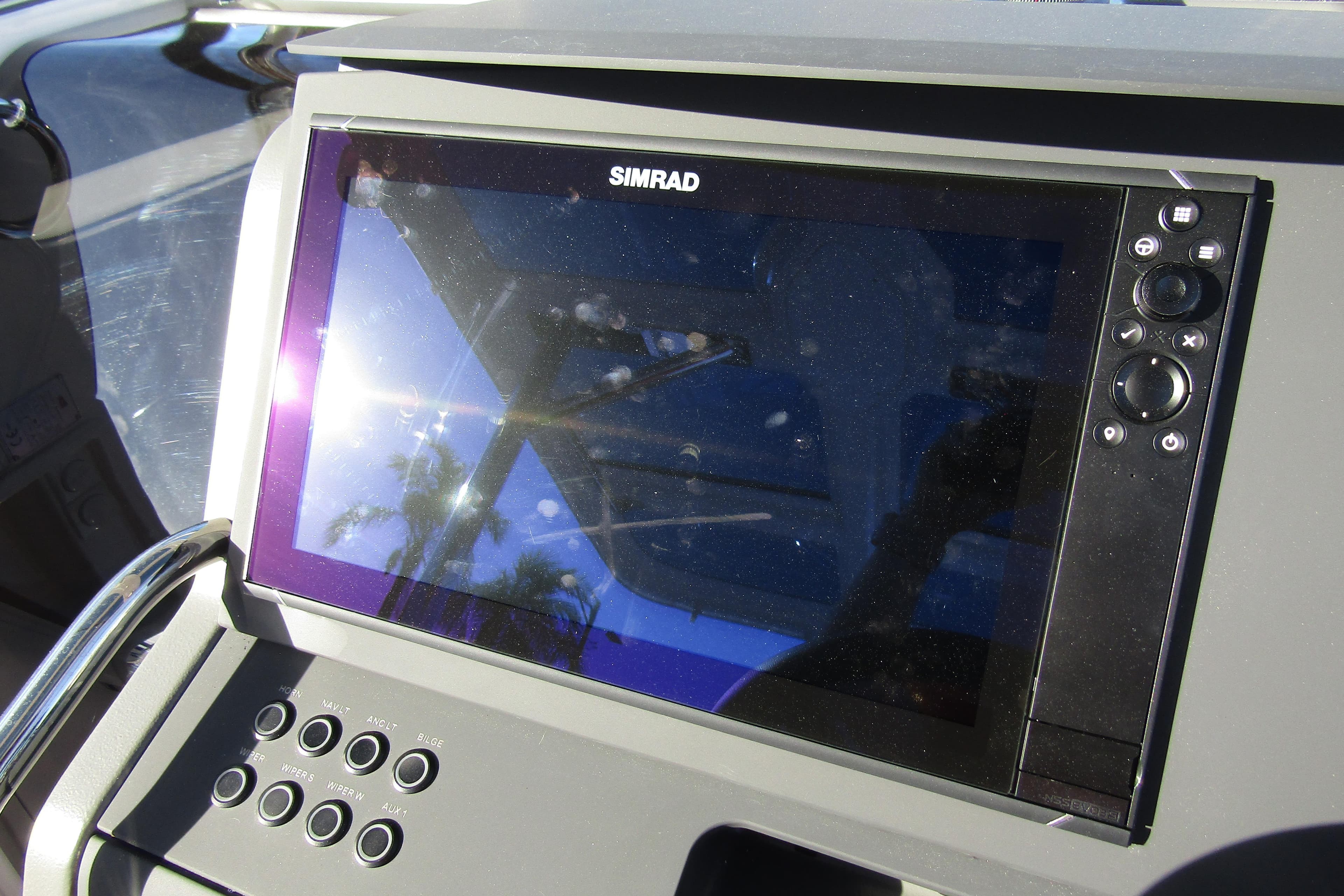 Simrad display on 2025 Nimbus Tender 9 boat dashboard, reflecting sunlight.