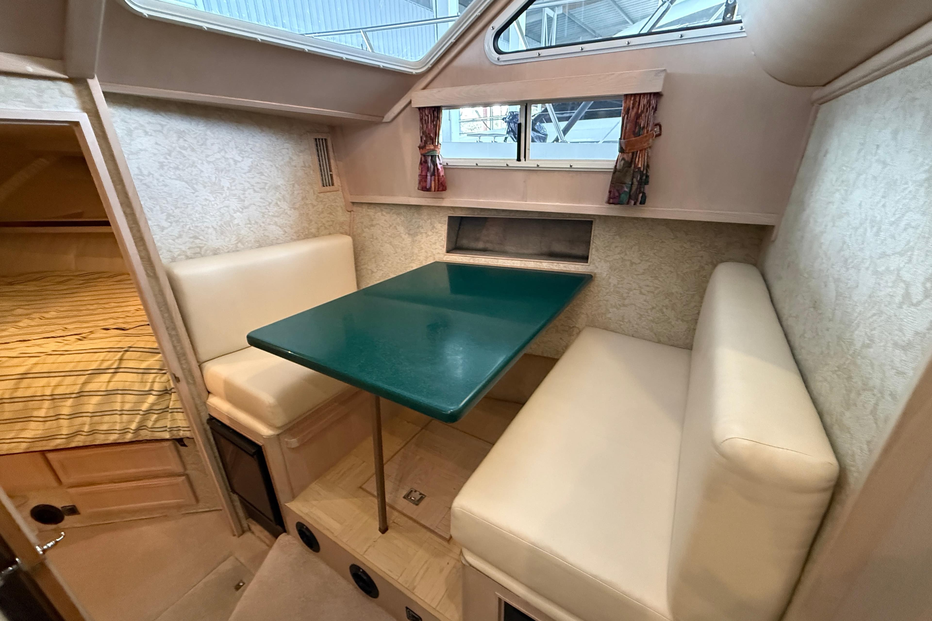 1994 Tollycraft 45 Cockpit Motor Yacht interior with dining area and cozy seating.