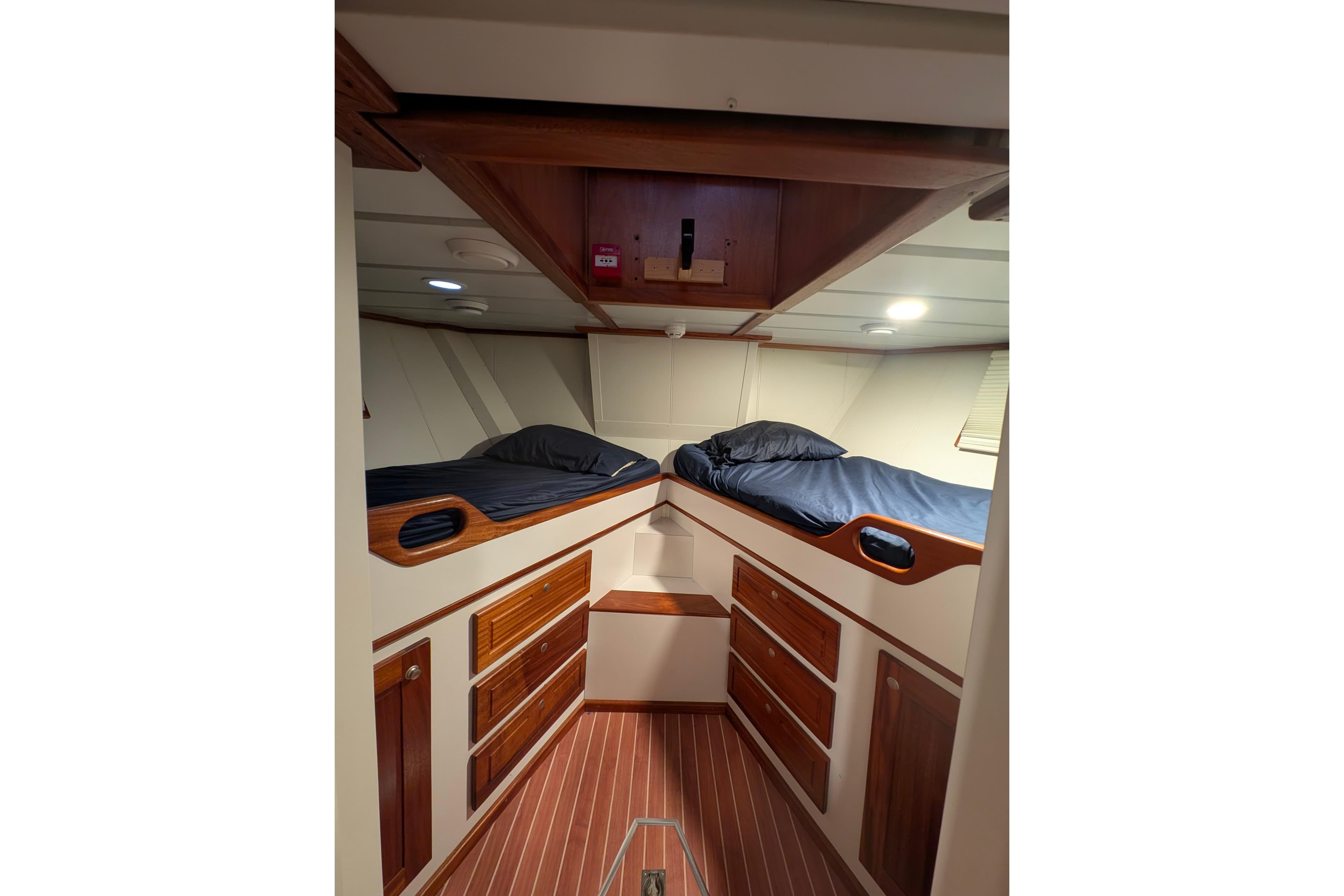 Luxurious 2001 Doggersbank yacht cabin with twin beds and elegant wood finish.