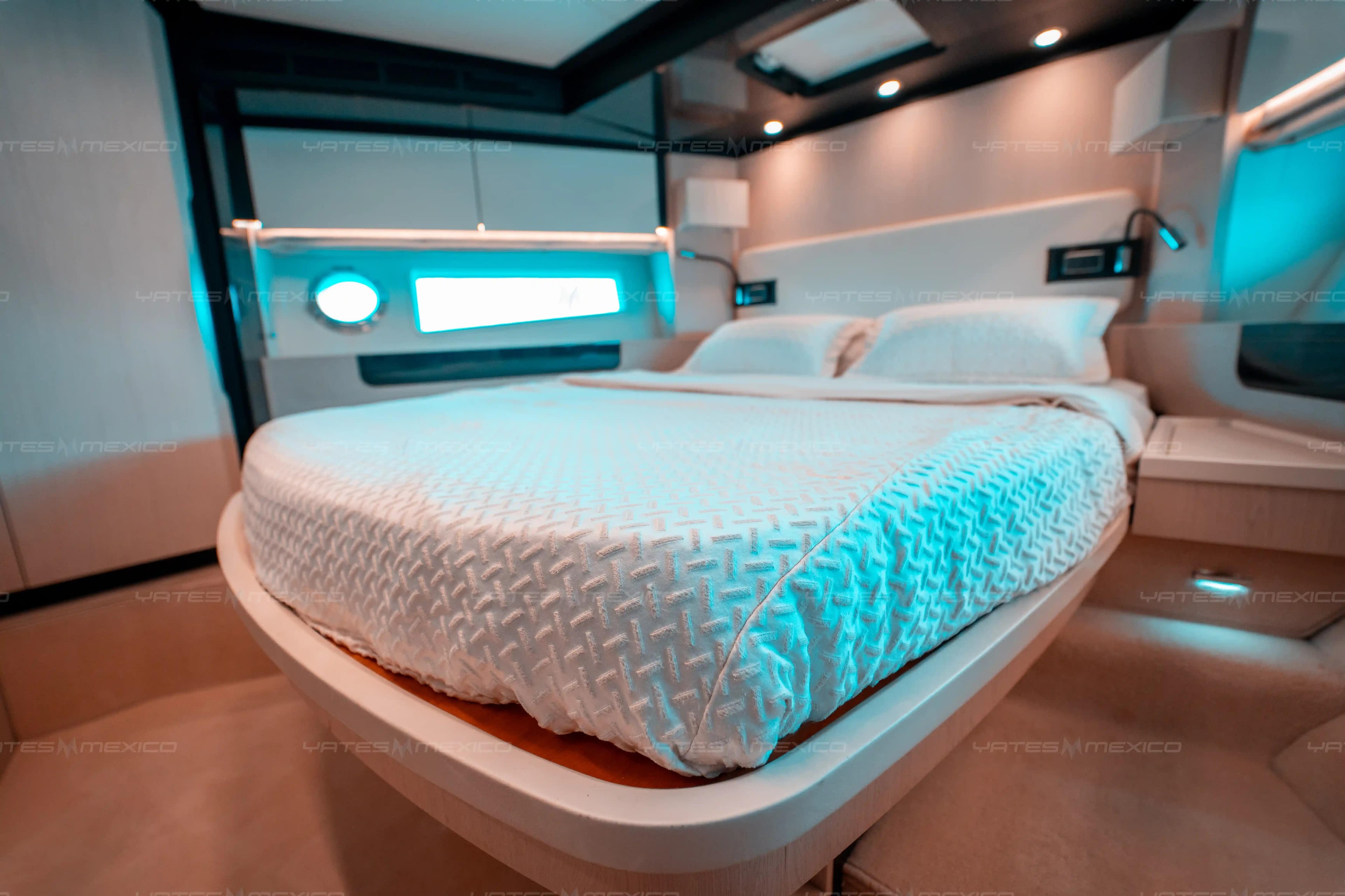 Luxurious bedroom interior of 2017 Azimut 66 yacht with modern design and ambient lighting.