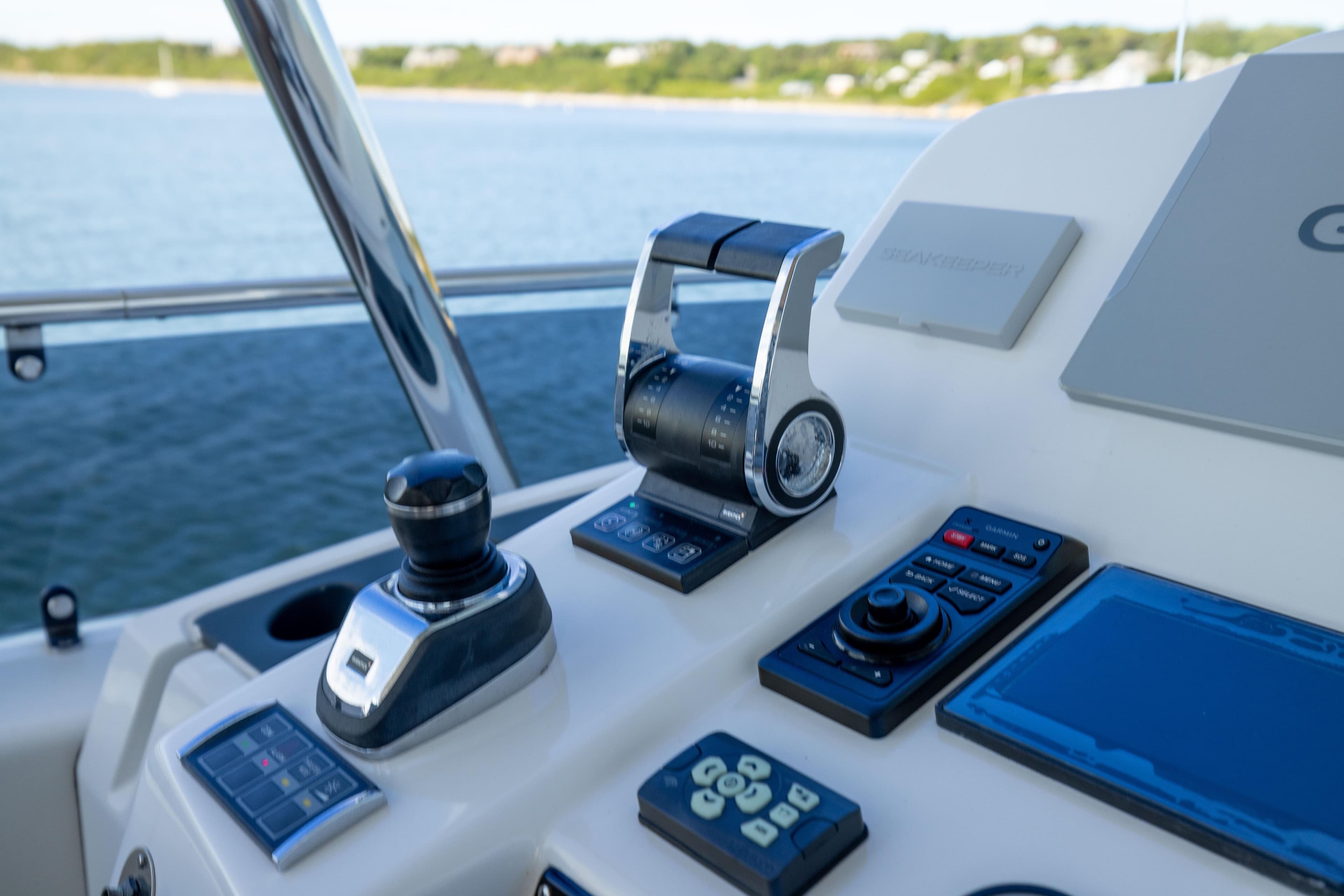 Cockpit controls of 2019 Sirena 64 yacht with navigation equipment and throttle levers.
