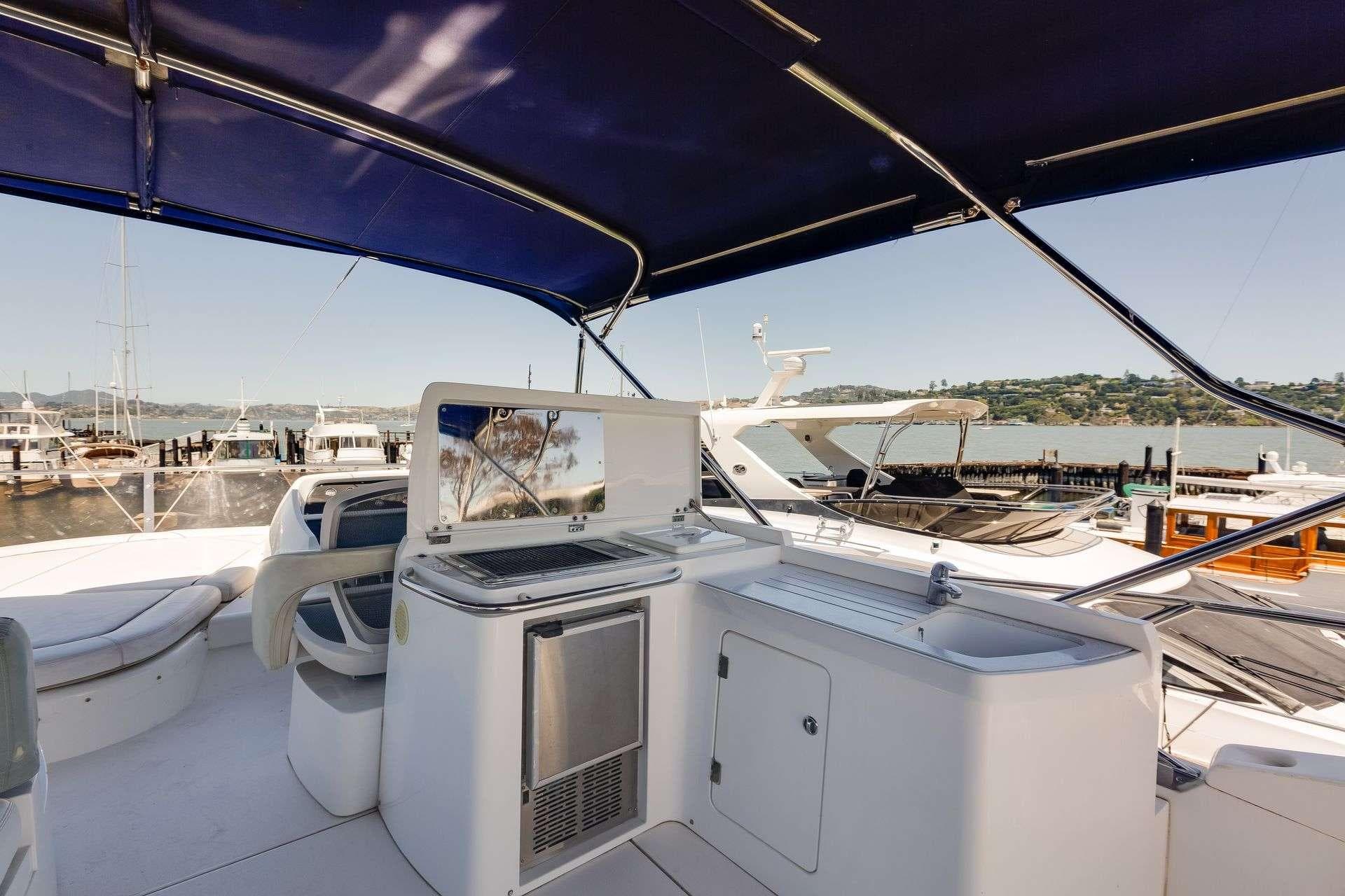 Luxurious 2009 Sunseeker Manhattan 70 yacht interior with modern amenities and scenic marina view.