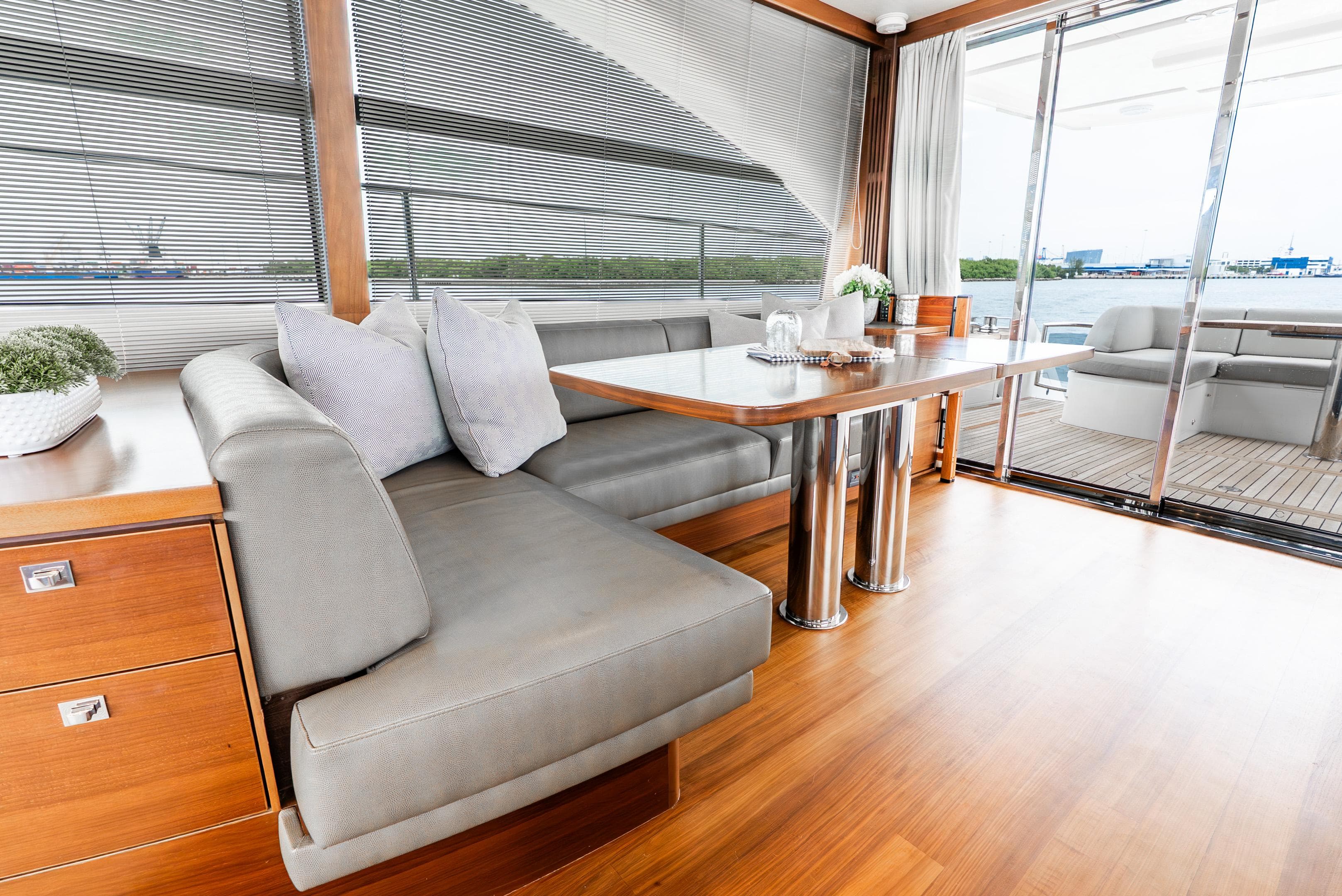 Luxurious interior of 2018 Princess F-68 yacht with elegant seating and dining area.