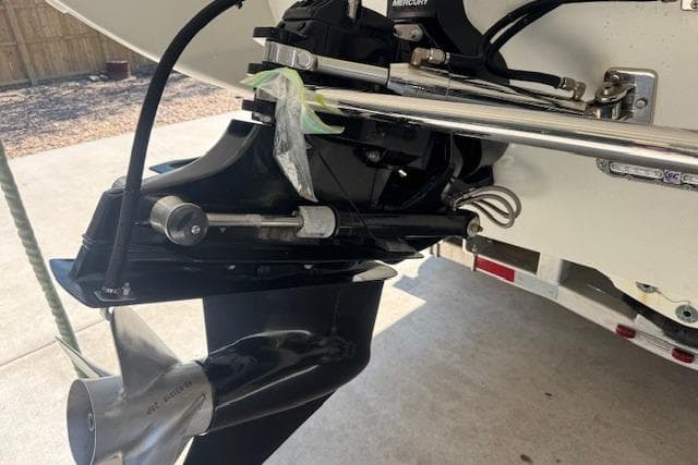 2007 Formula 353 FASTech boat propeller and engine detail in a driveway setting.
