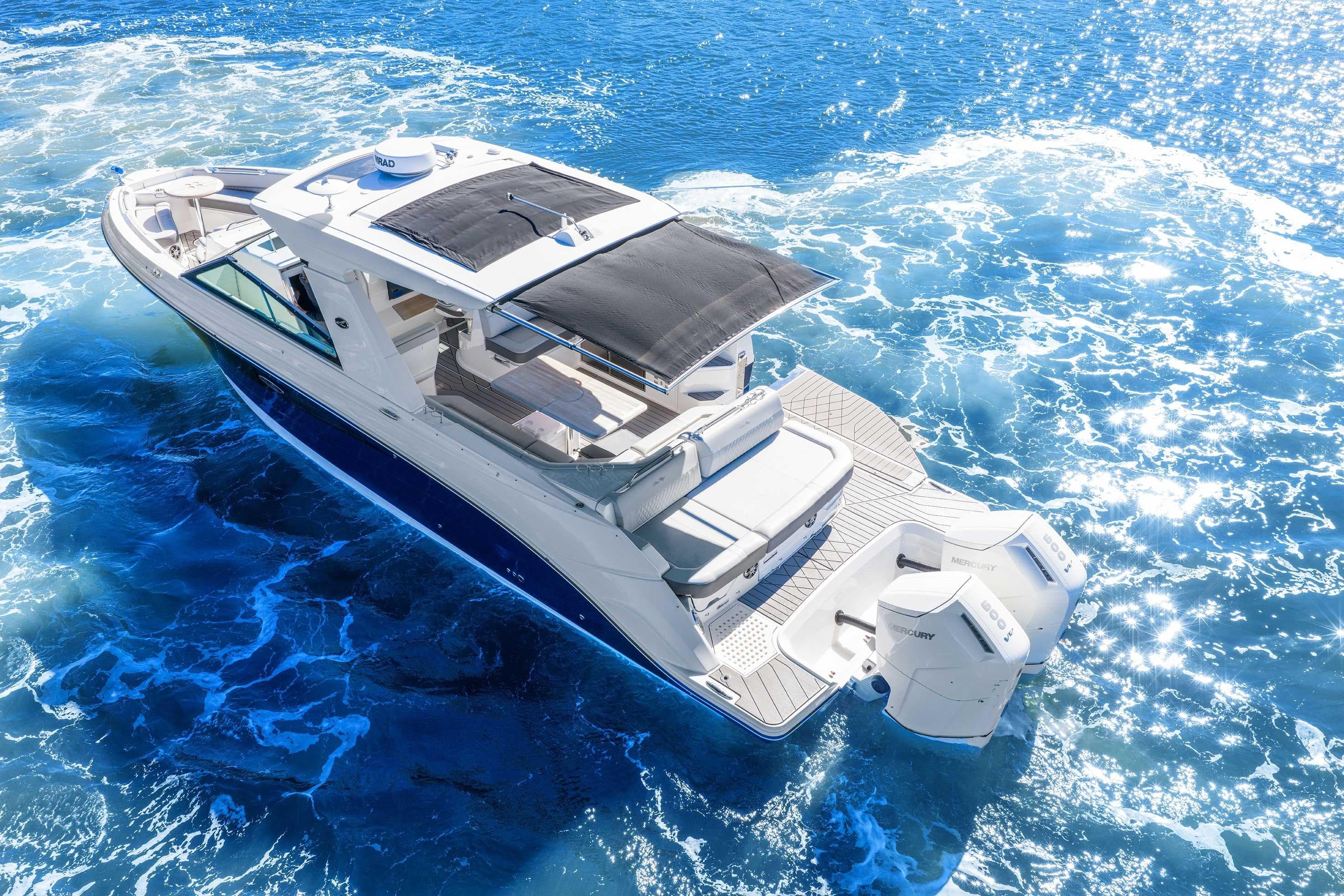 2023 Sea Ray SLX 400 Outboard cruising on sparkling blue ocean waters.