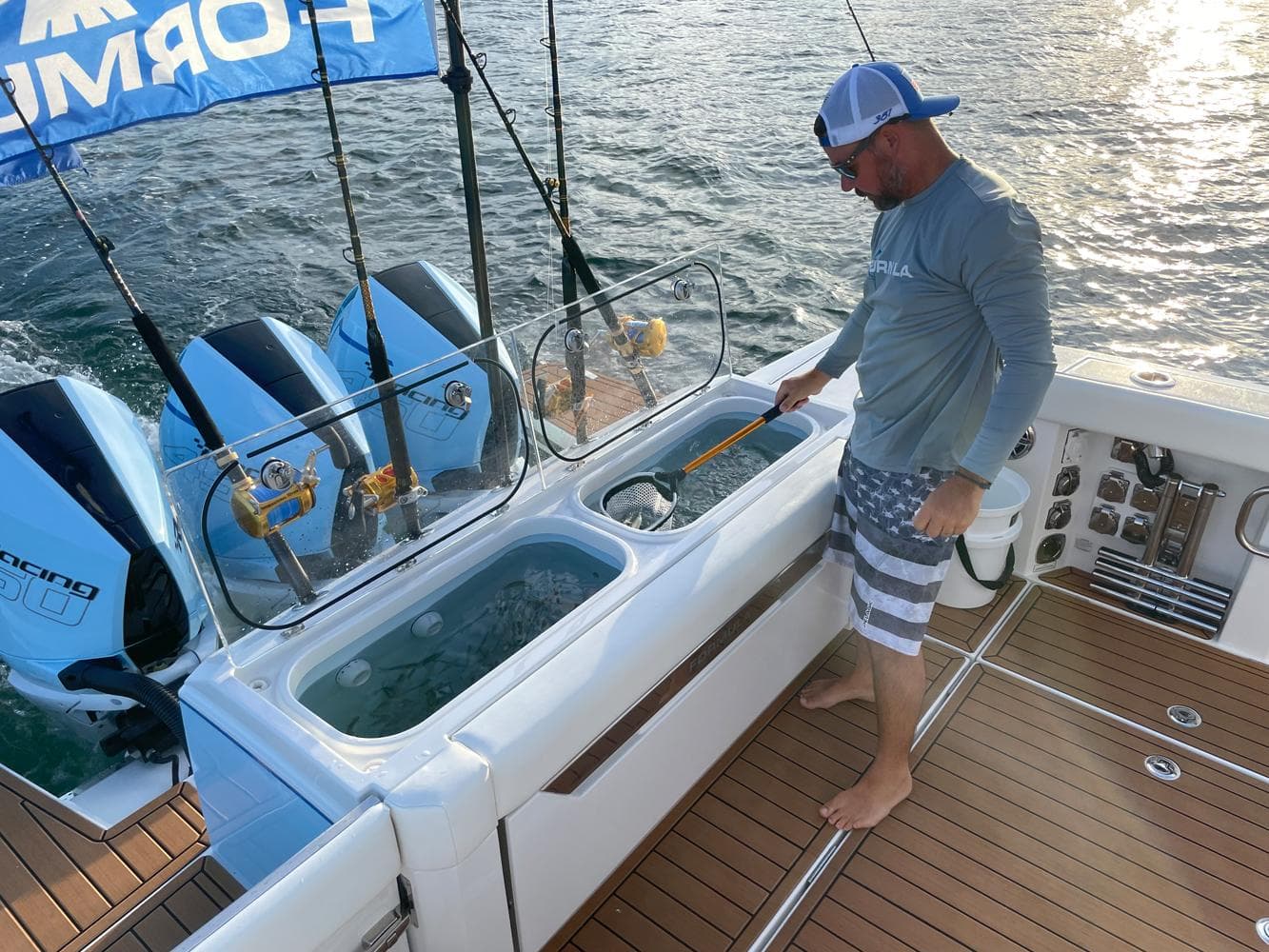 Man fishing on 2023 Formula 387 Center Console Fish boat with twin engines.