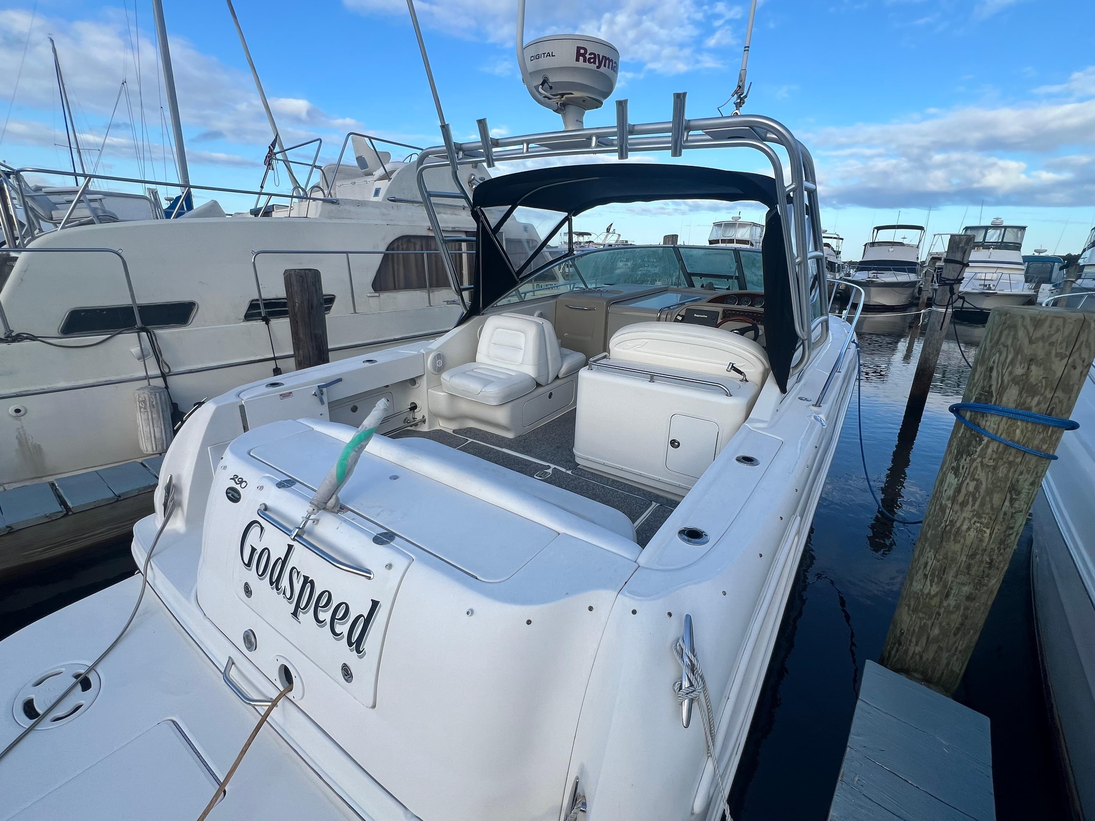 2007 Sea Ray 290 Amberjack boat docked at marina, featuring spacious seating and radar equipment.
