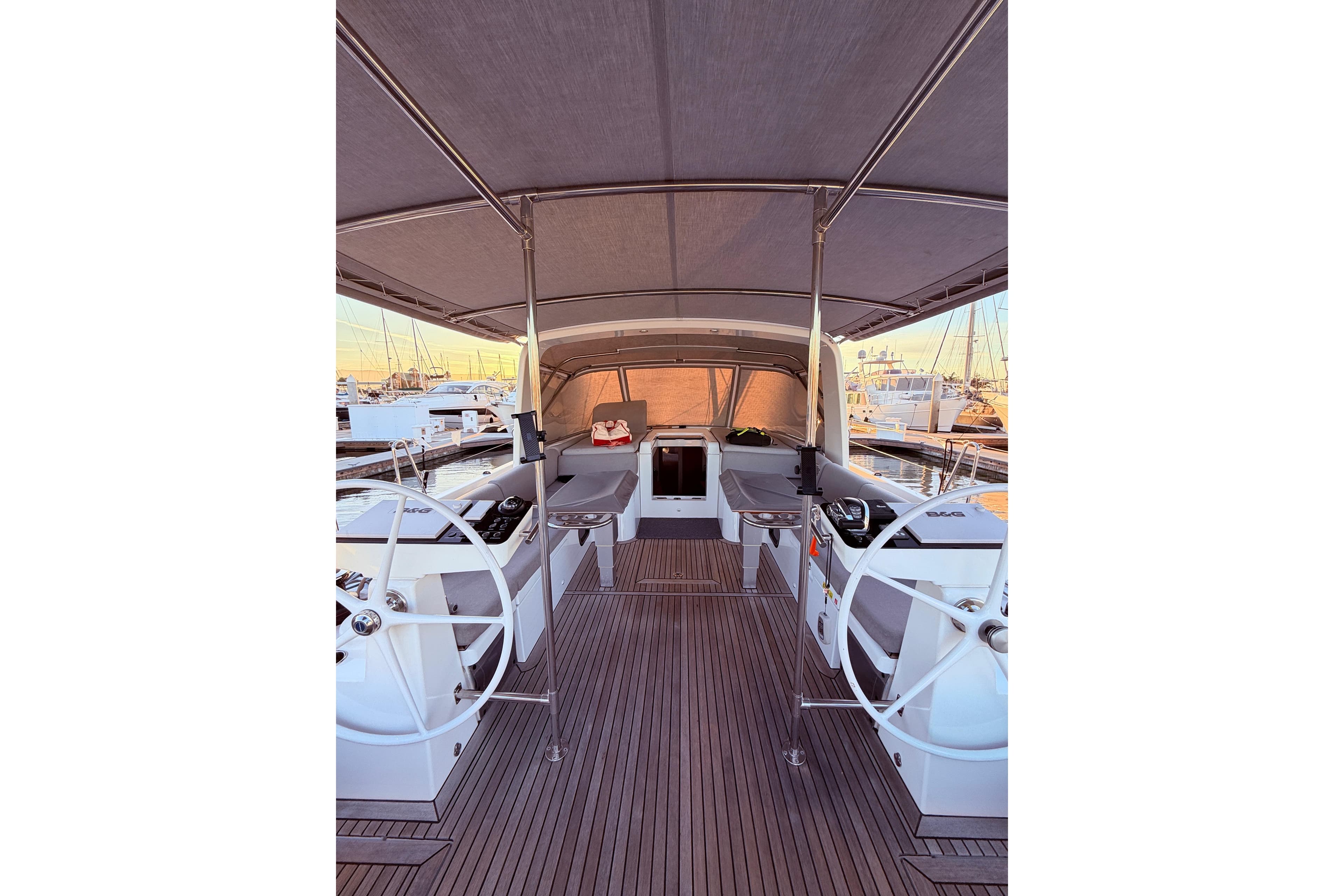 2022 Beneteau Oceanis Yacht 54 cockpit with dual steering wheels and spacious seating.