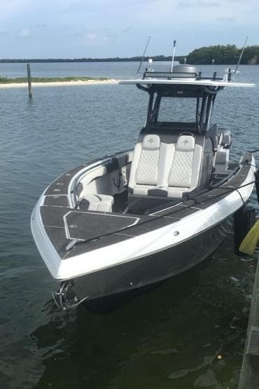 2019 Statement 350 Open boat docked on calm water.