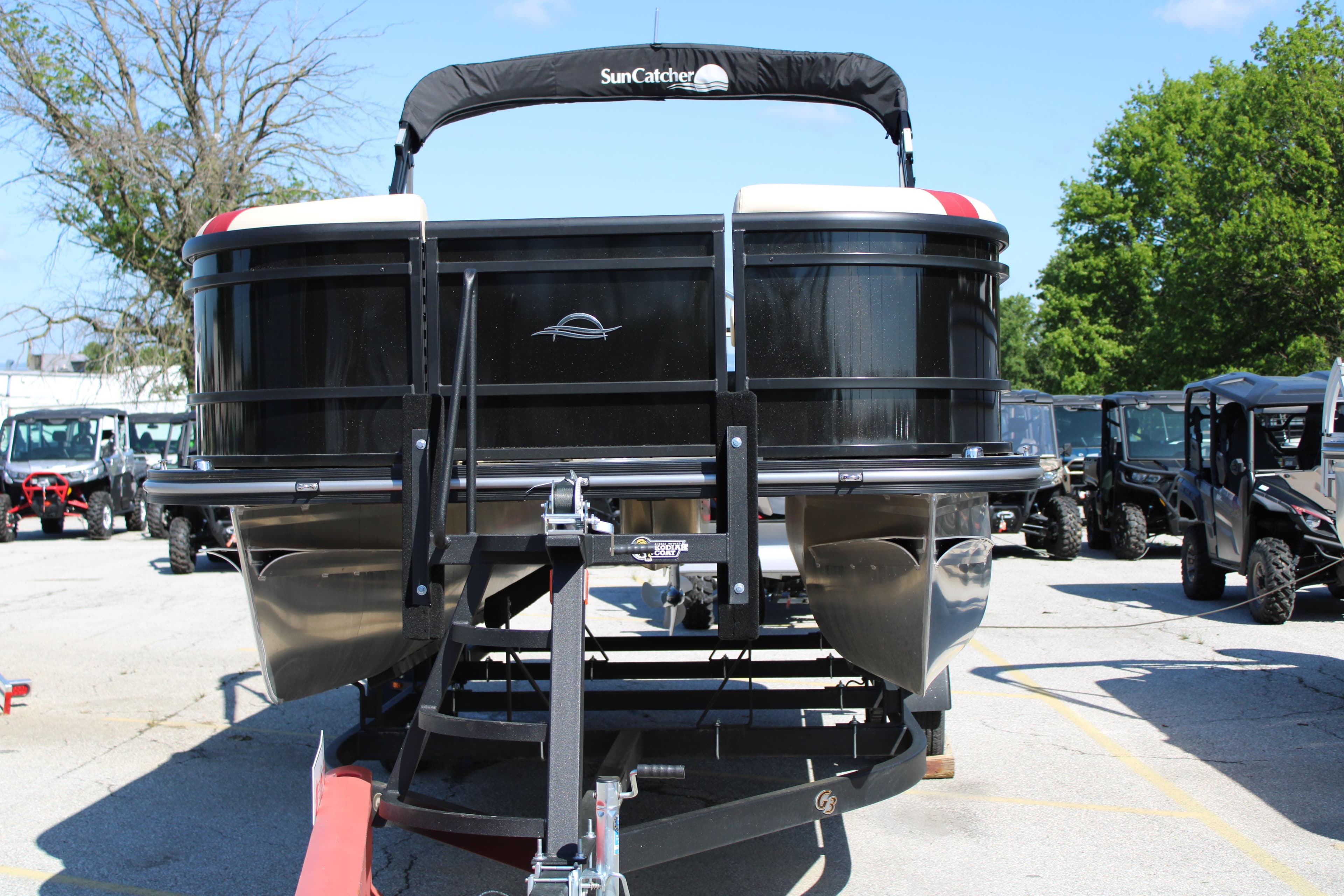 2025 SunCatcher Select 20RC pontoon boat on trailer in outdoor lot.