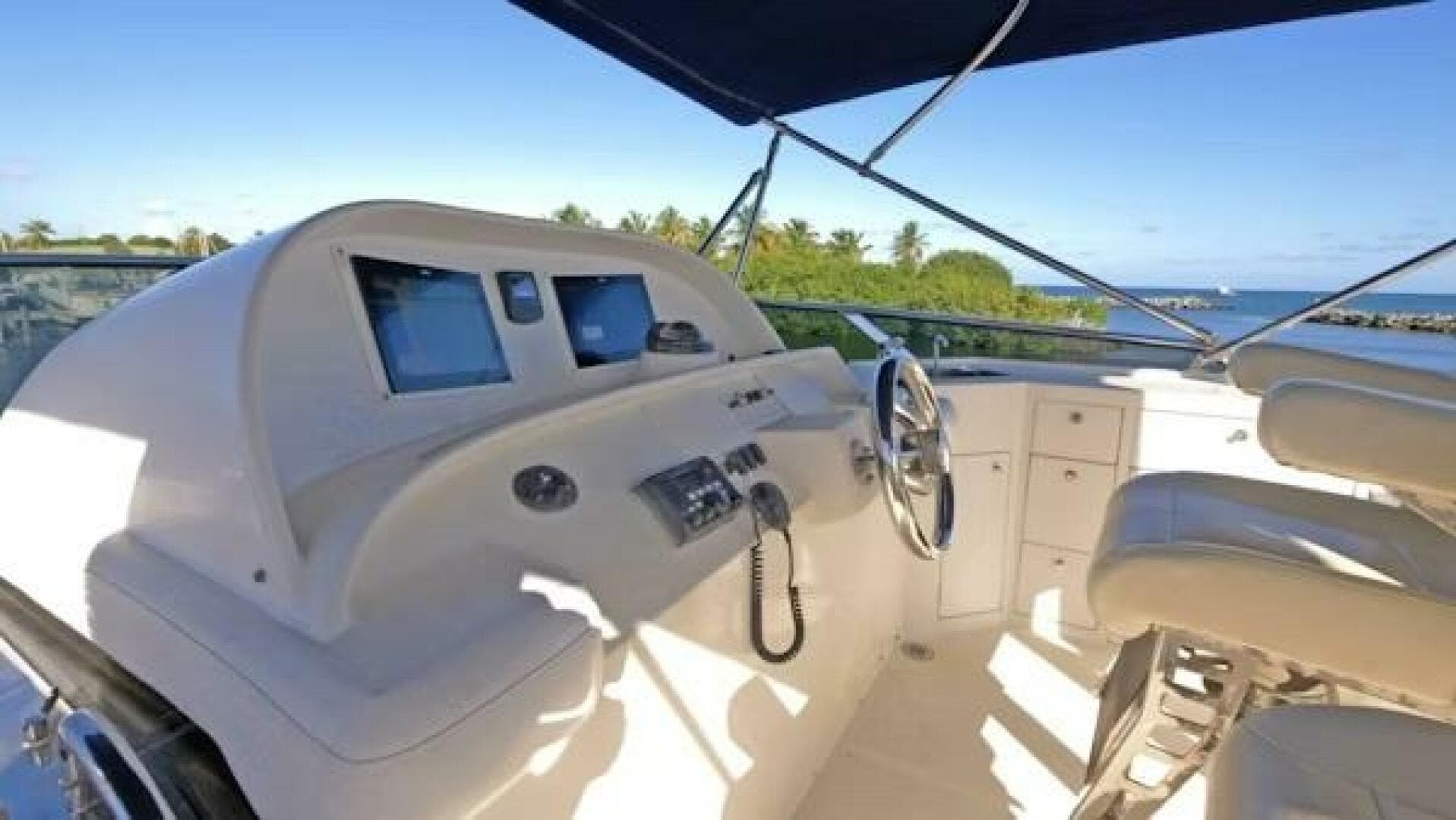 2004 McKinna Pilothouse yacht helm with dual screens and ocean view.