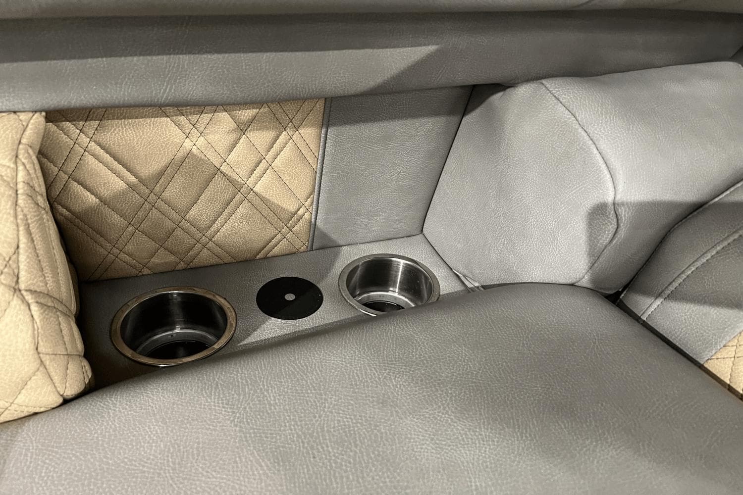 Luxurious seating with cup holders in 2024 Premier 230 Intrigue boat interior.
