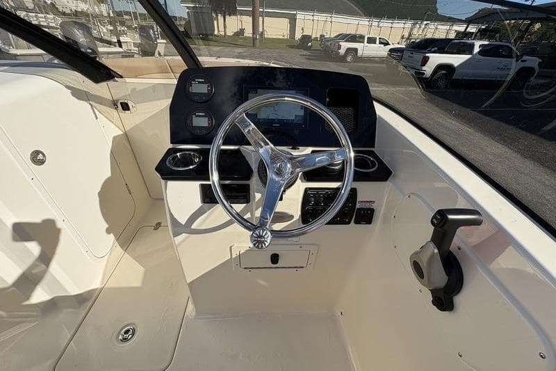 2026 Scout 222 Dorado boat cockpit with steering wheel and control panel.