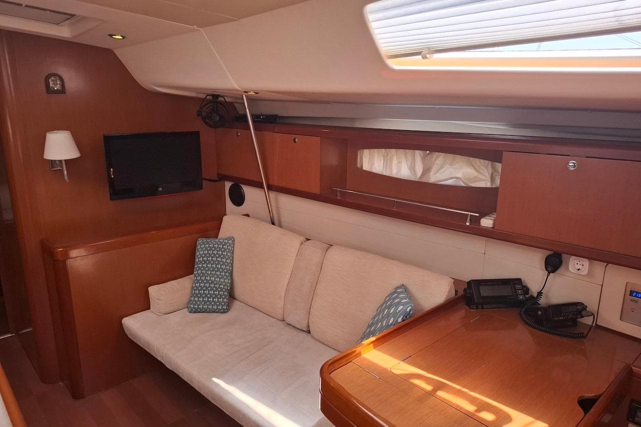 Interior of 2009 Beneteau Oceanis 54 yacht with cozy seating and modern amenities.