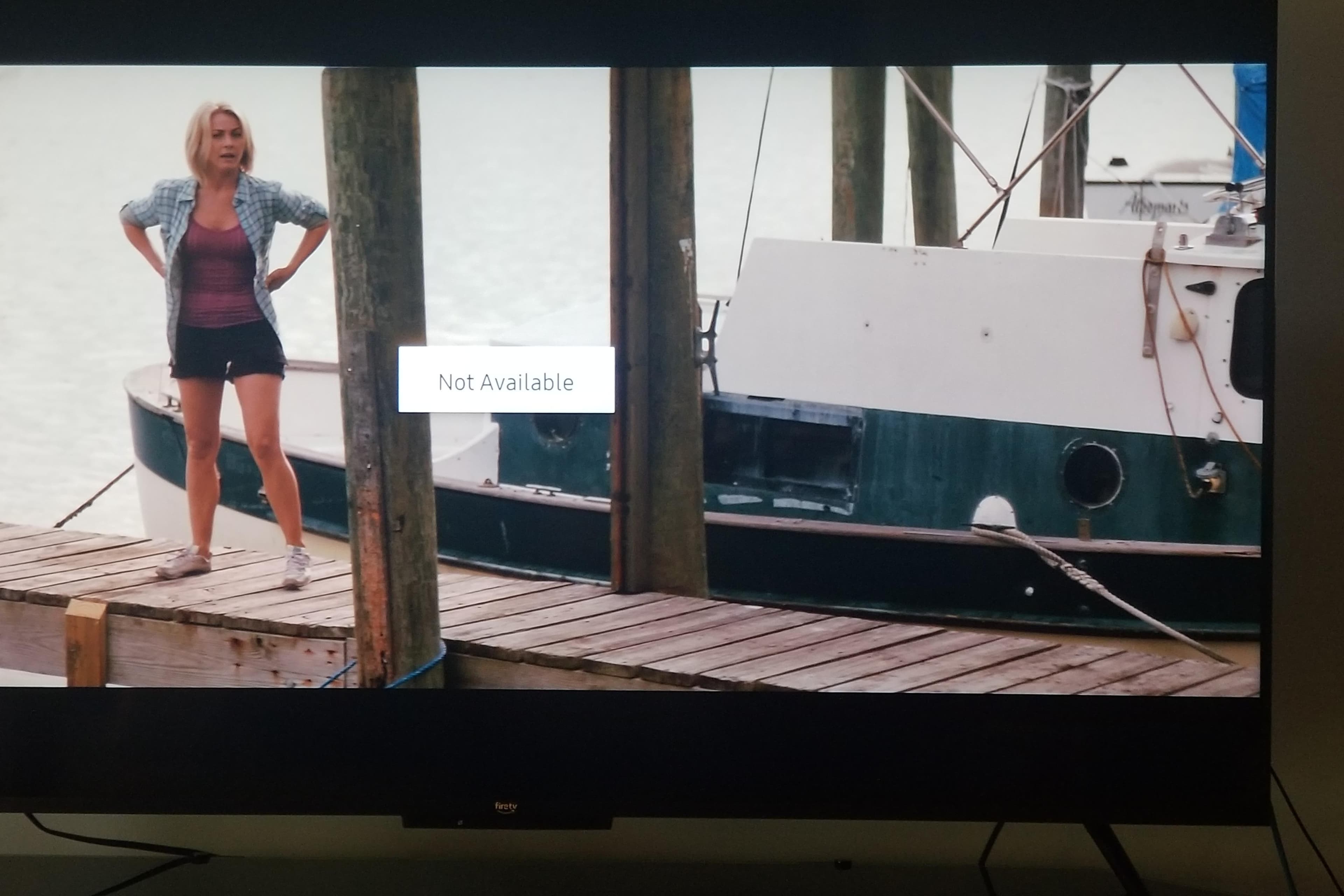Woman standing on dock near 1974 Fales Navigator boat, with "Not Available" message displayed.