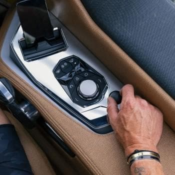 Close-up of Nautique G25 Paragon MY2026 control panel with hand adjusting settings.