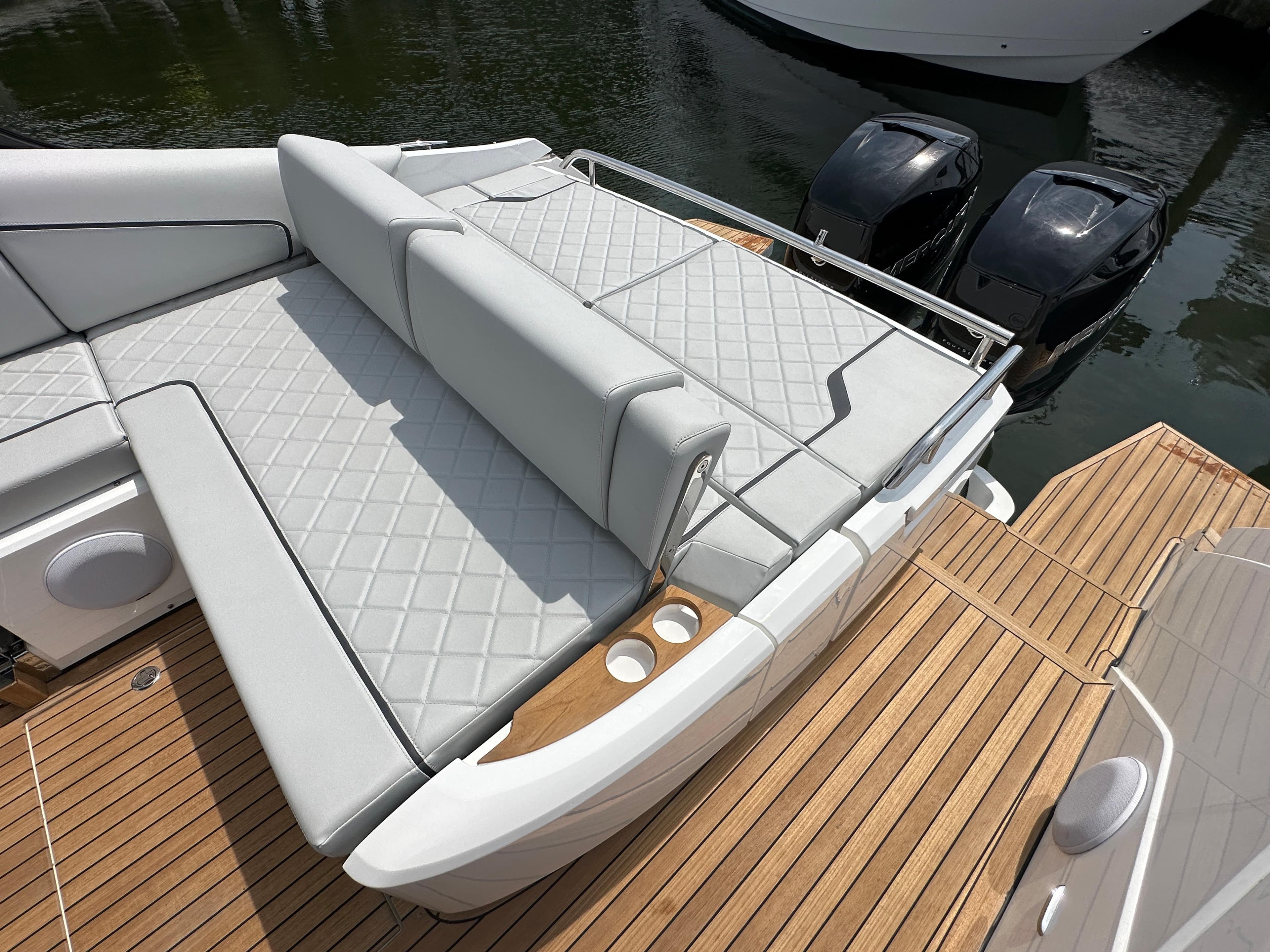 2023 Fairline F//Line 33 Outboard luxury boat with cushioned seating and twin engines.