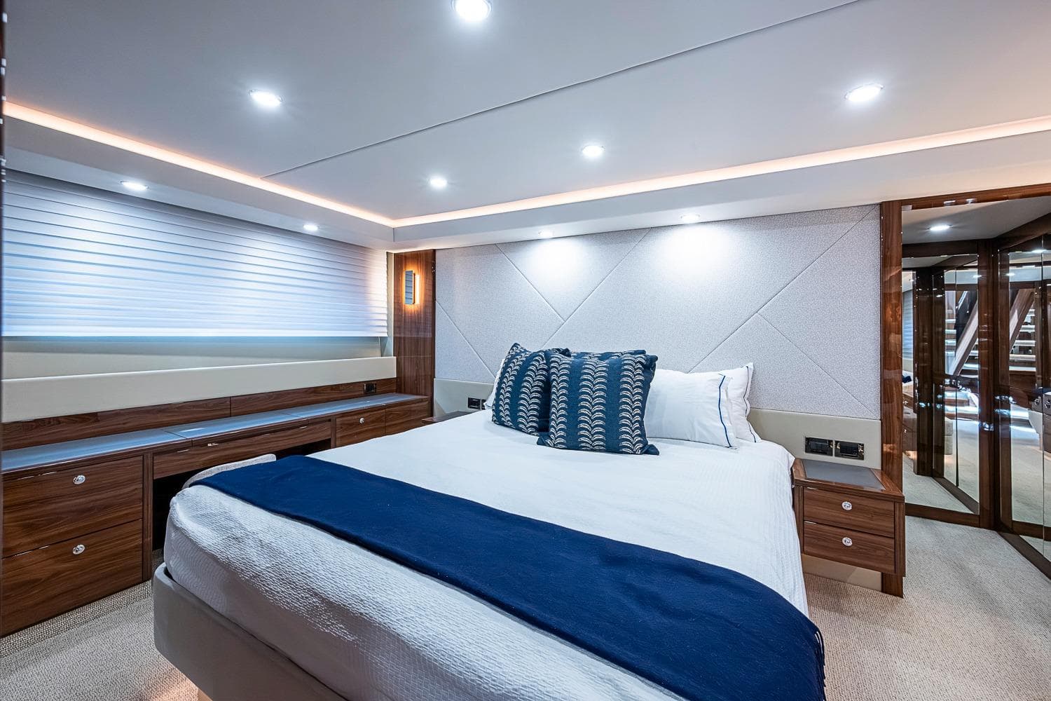 Luxurious bedroom interior of 2025 Maritimo M75 yacht with modern design and elegant lighting.