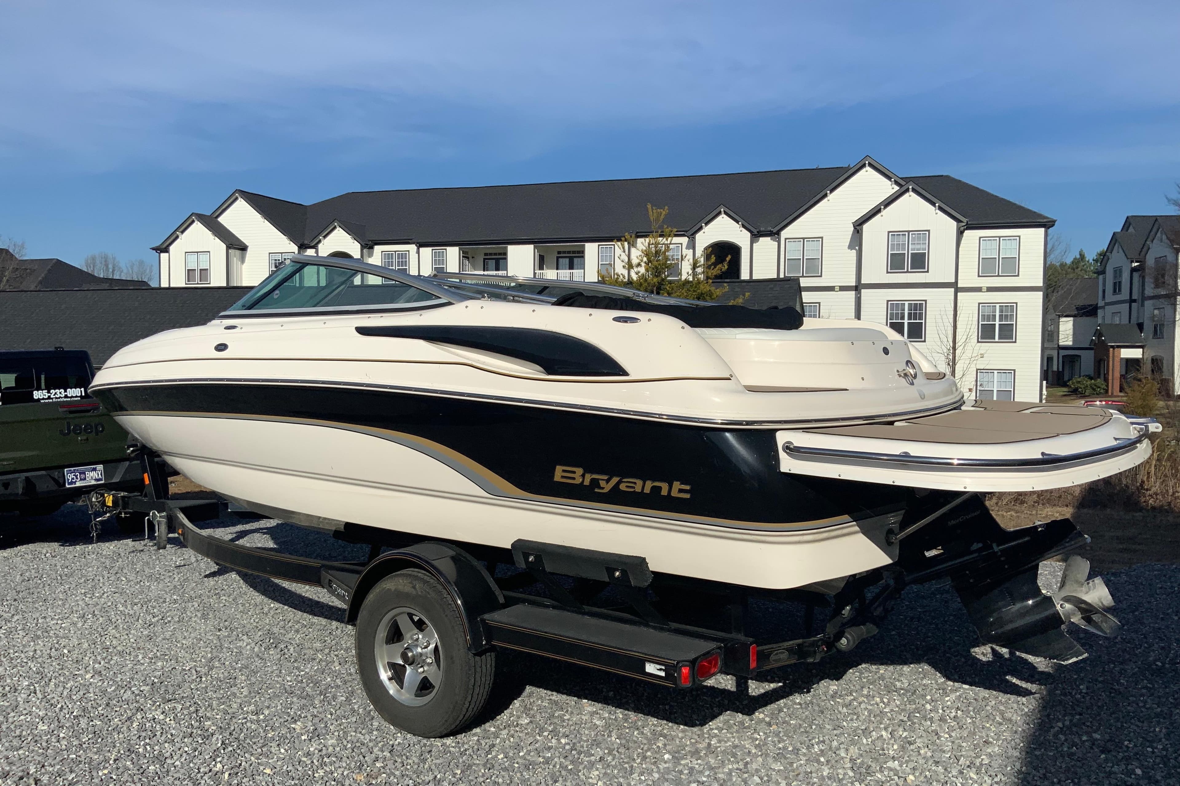 2007 Bryant 206 boat on trailer, parked in residential area.