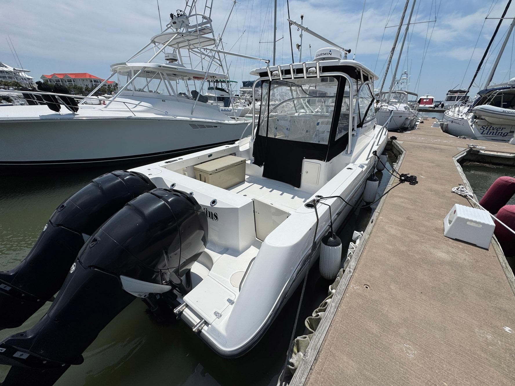 2011 Boston Whaler 305 Conquest docked, featuring dual outboard engines.