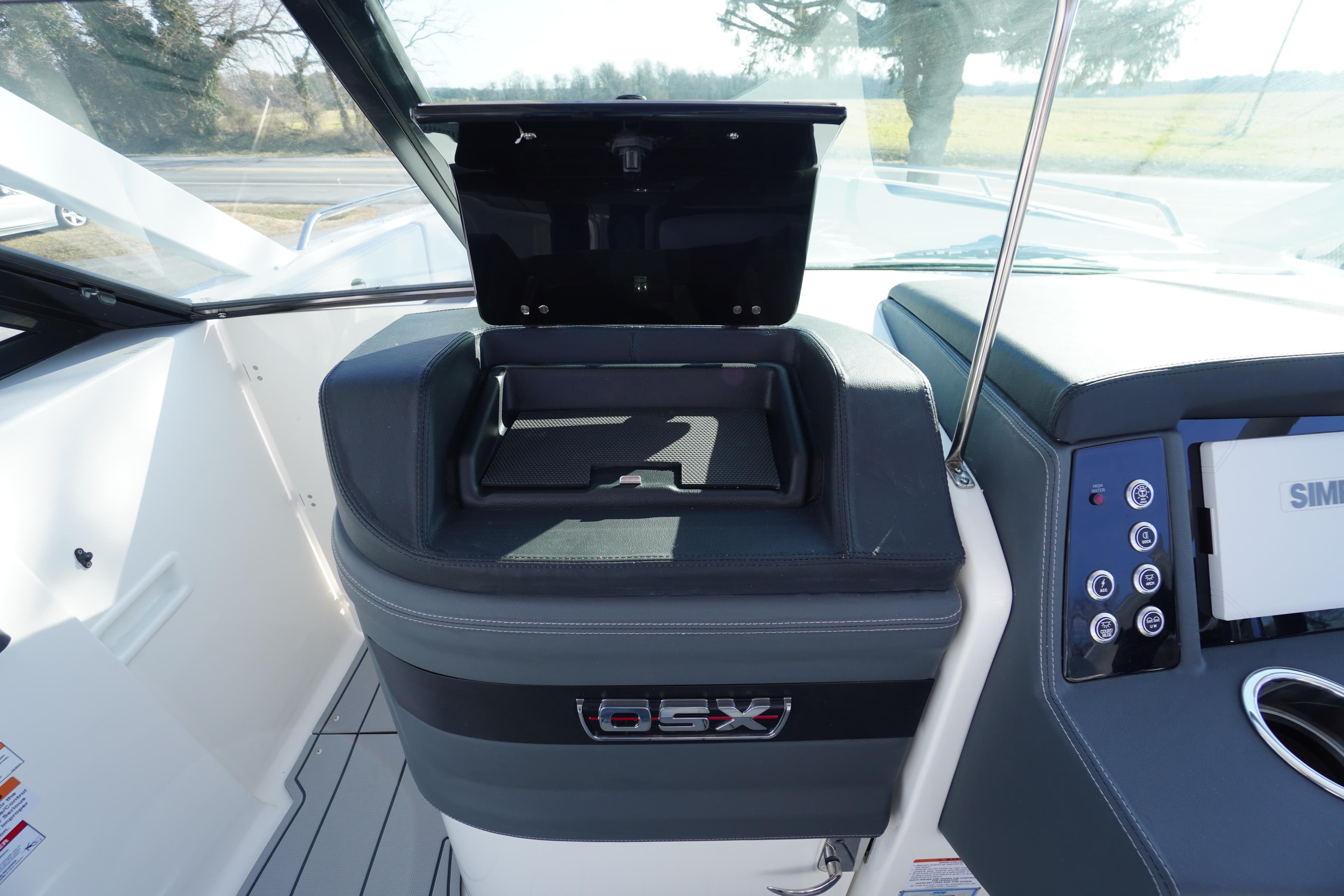 2026 Chaparral 280 OSX boat dashboard with storage compartment and control panel.