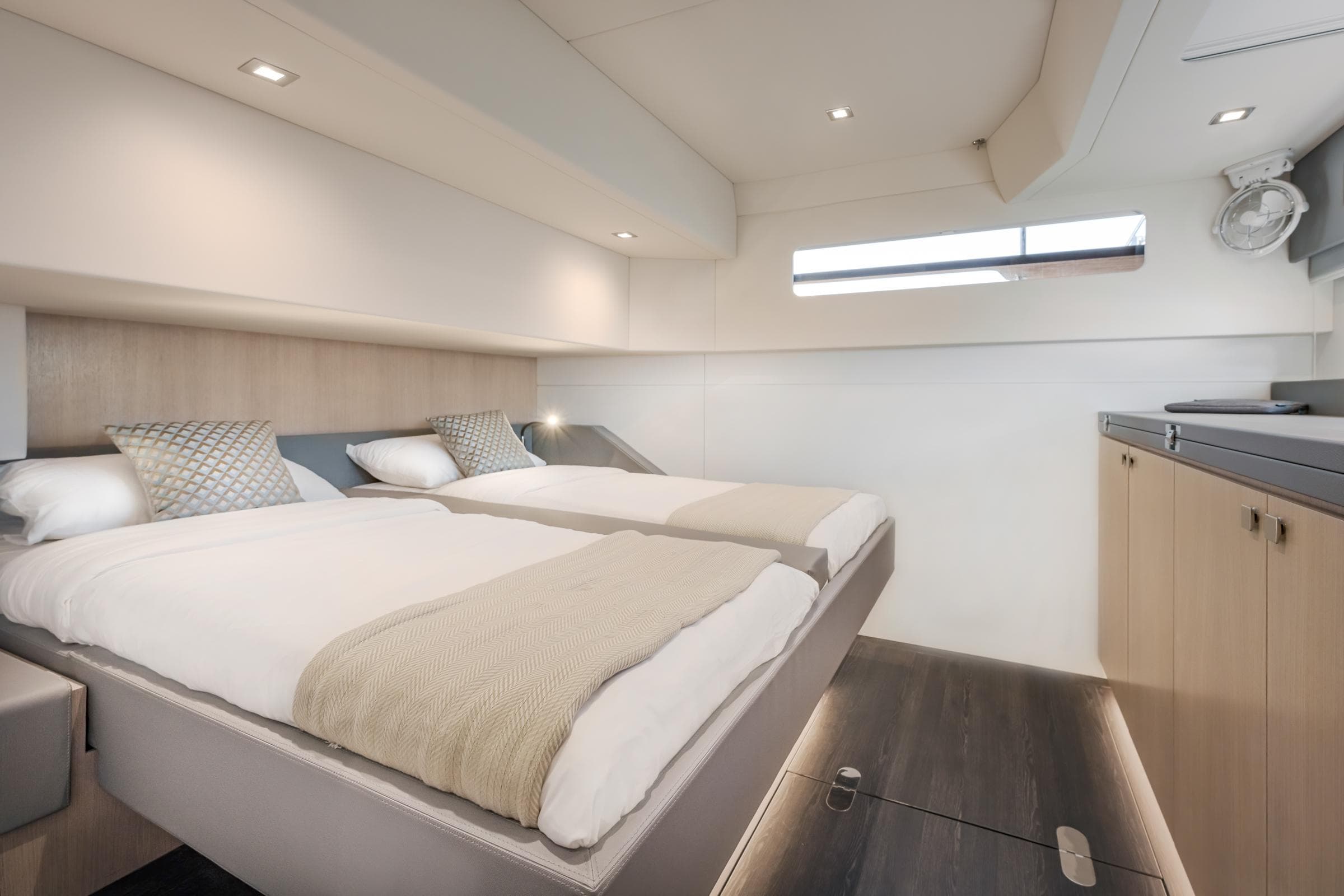 Luxurious cabin interior of 2025 Privilege Signature 650 yacht with twin beds and modern design.