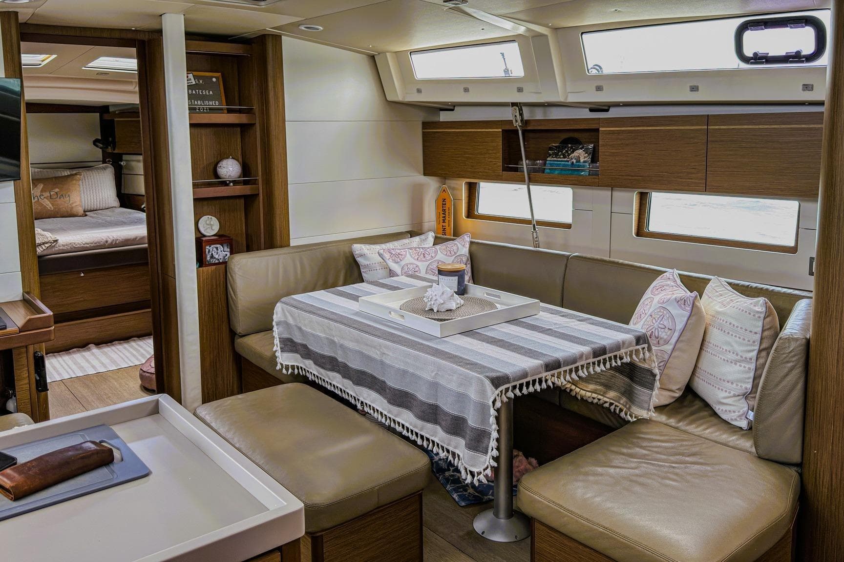 Interior of 2020 Beneteau Oceanis 46.1 yacht with cozy seating and dining area.