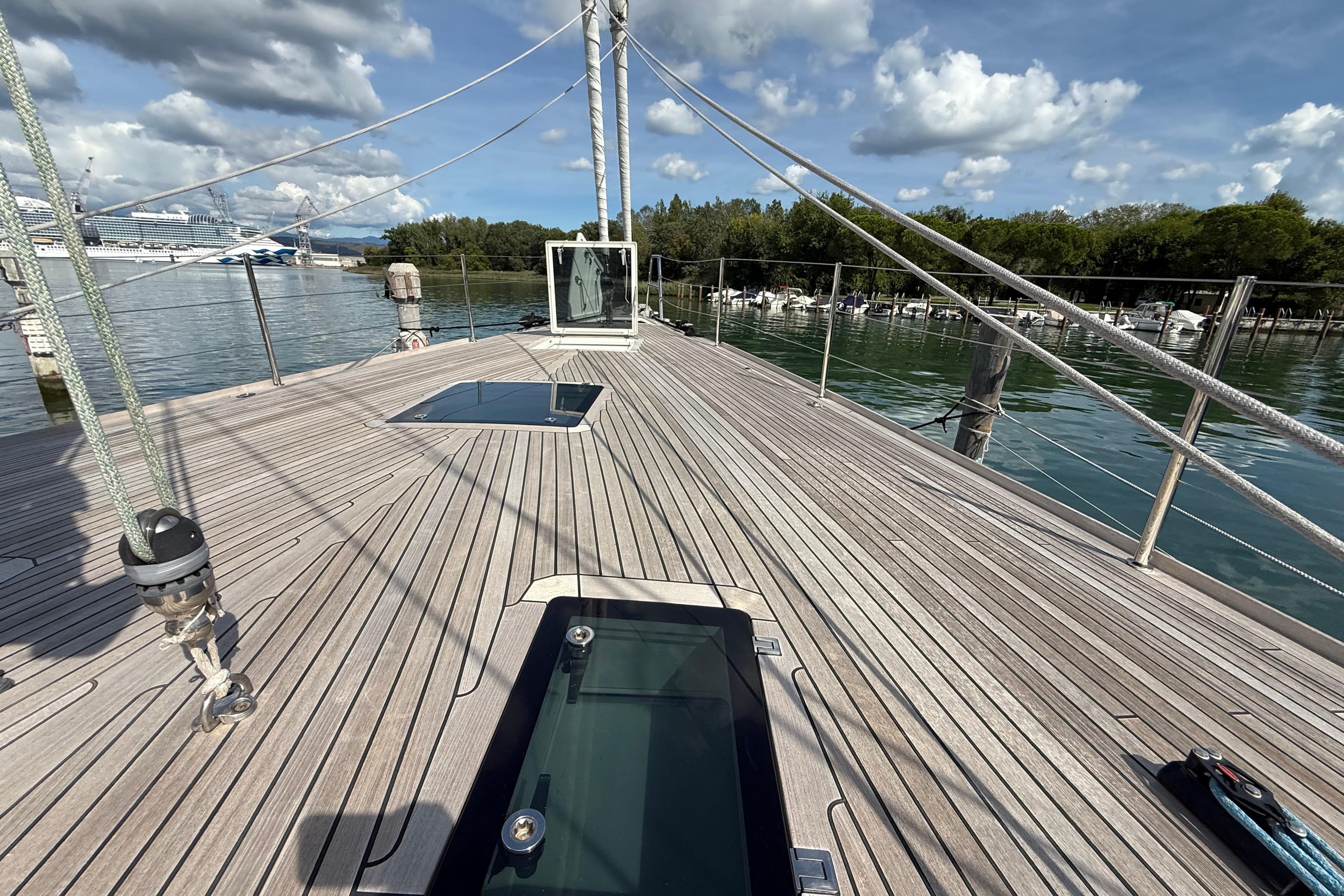 Deck of 2018 Contest 67CS yacht with scenic marina view.