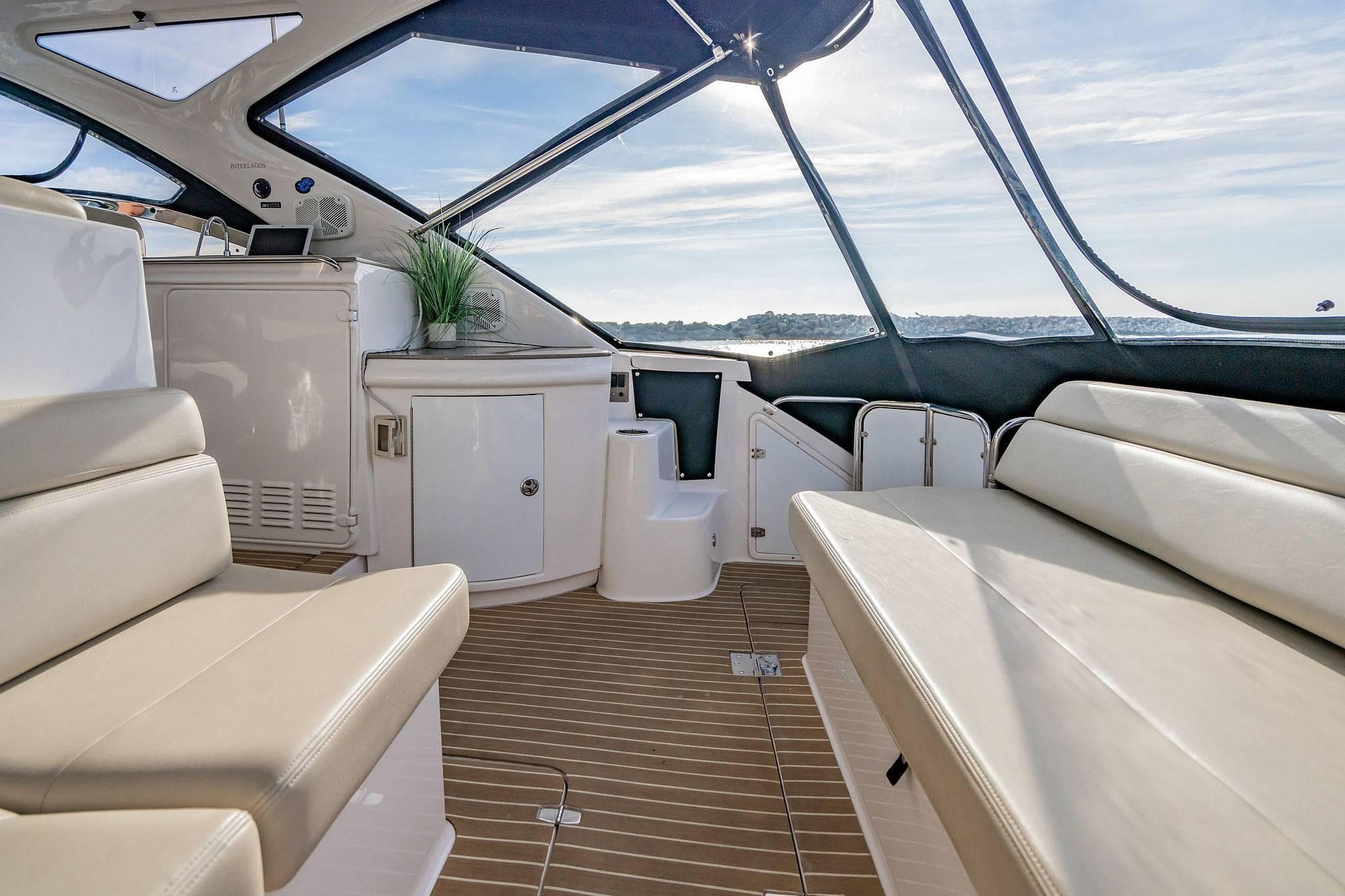 Luxurious interior of 2010 Regal Commodore 4460 yacht with elegant seating and panoramic windows.