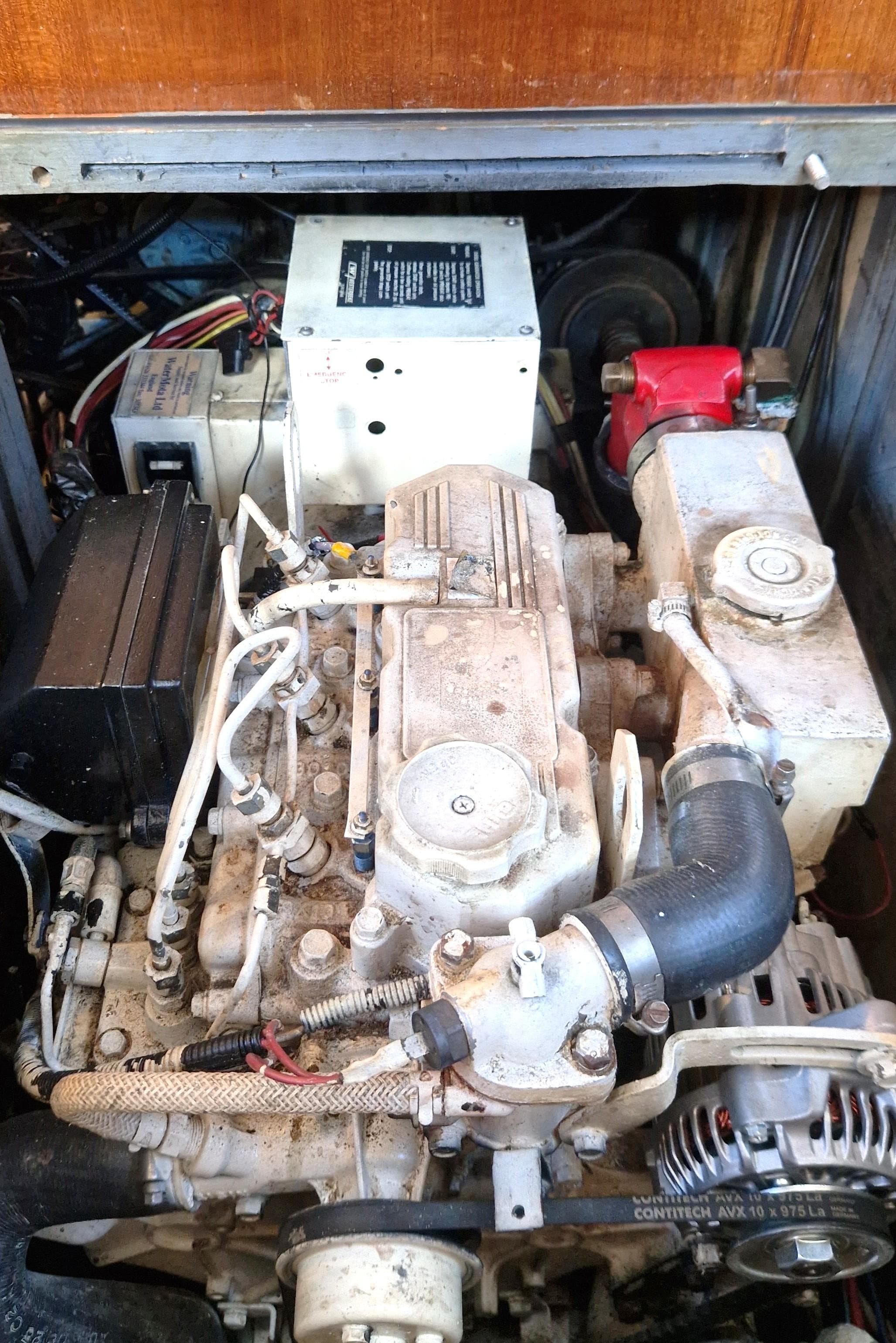 Engine compartment of a 1995 Oyster 55 yacht, showcasing mechanical components and wiring.