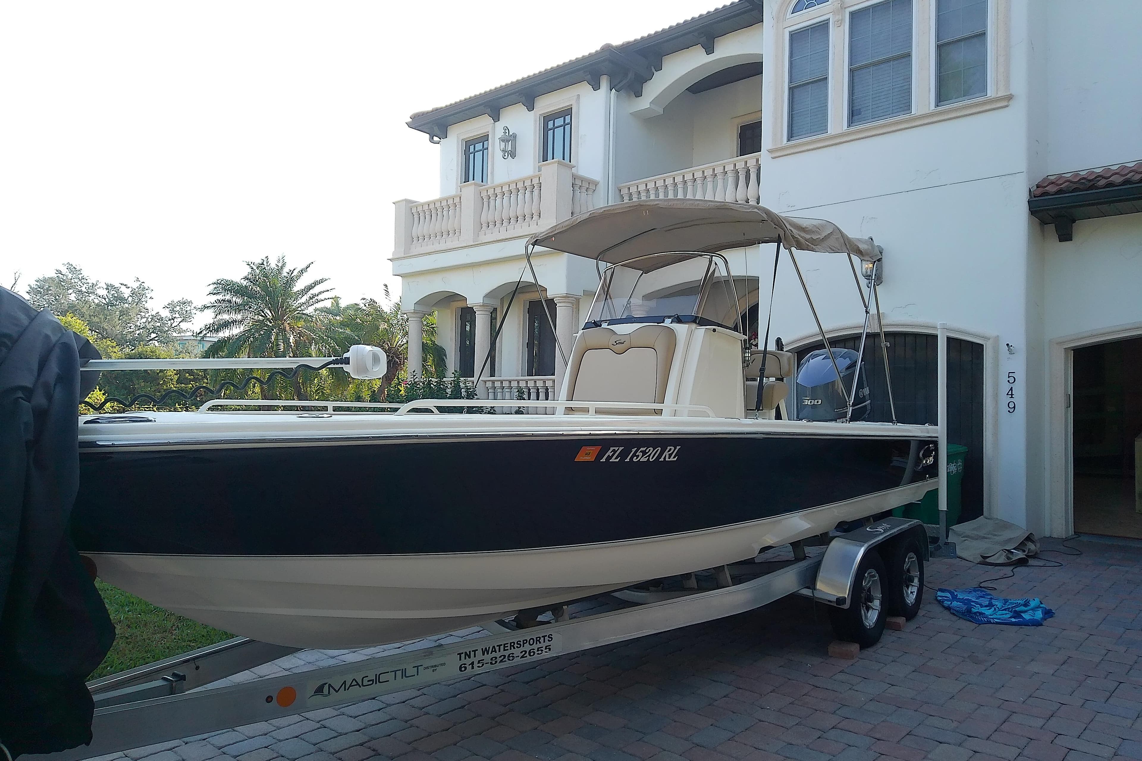 2018 Scout 251 XSS boat on trailer in front of a house.