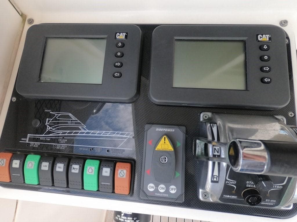 Control panel of a 2003 Riviera 58 Convertible yacht with dual CAT displays.