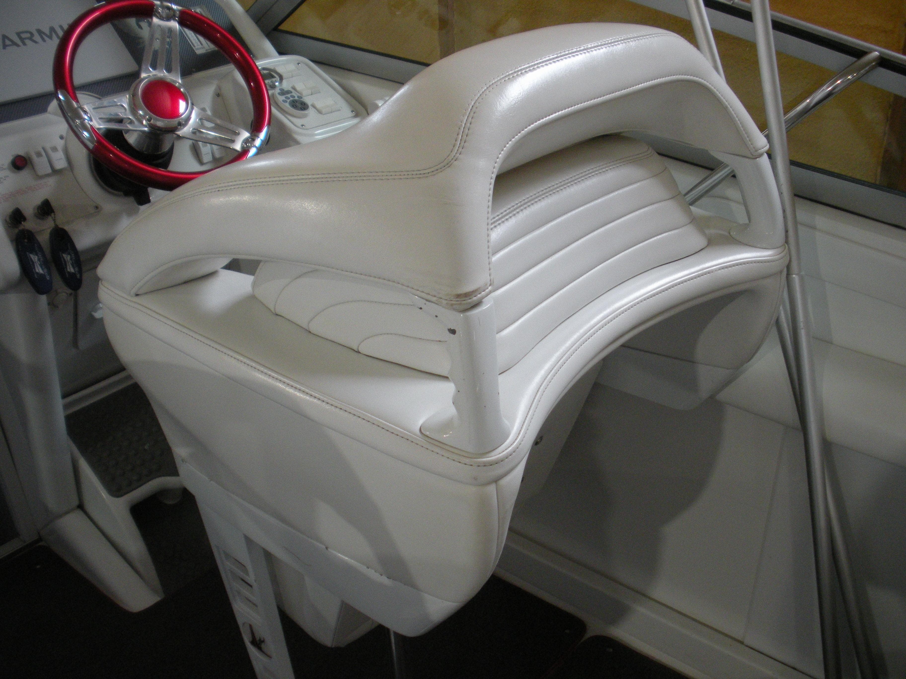 2001 Fountain 35 Fastech boat interior with white leather seat and red steering wheel.