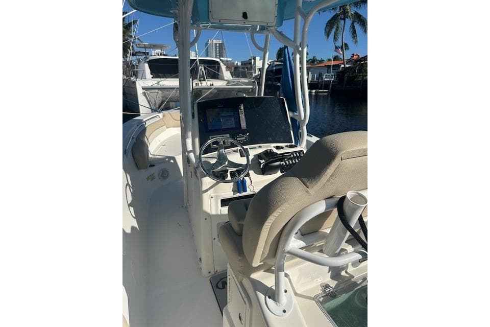 2018 NauticStar 2602 Legacy boat interior with steering wheel and navigation equipment.