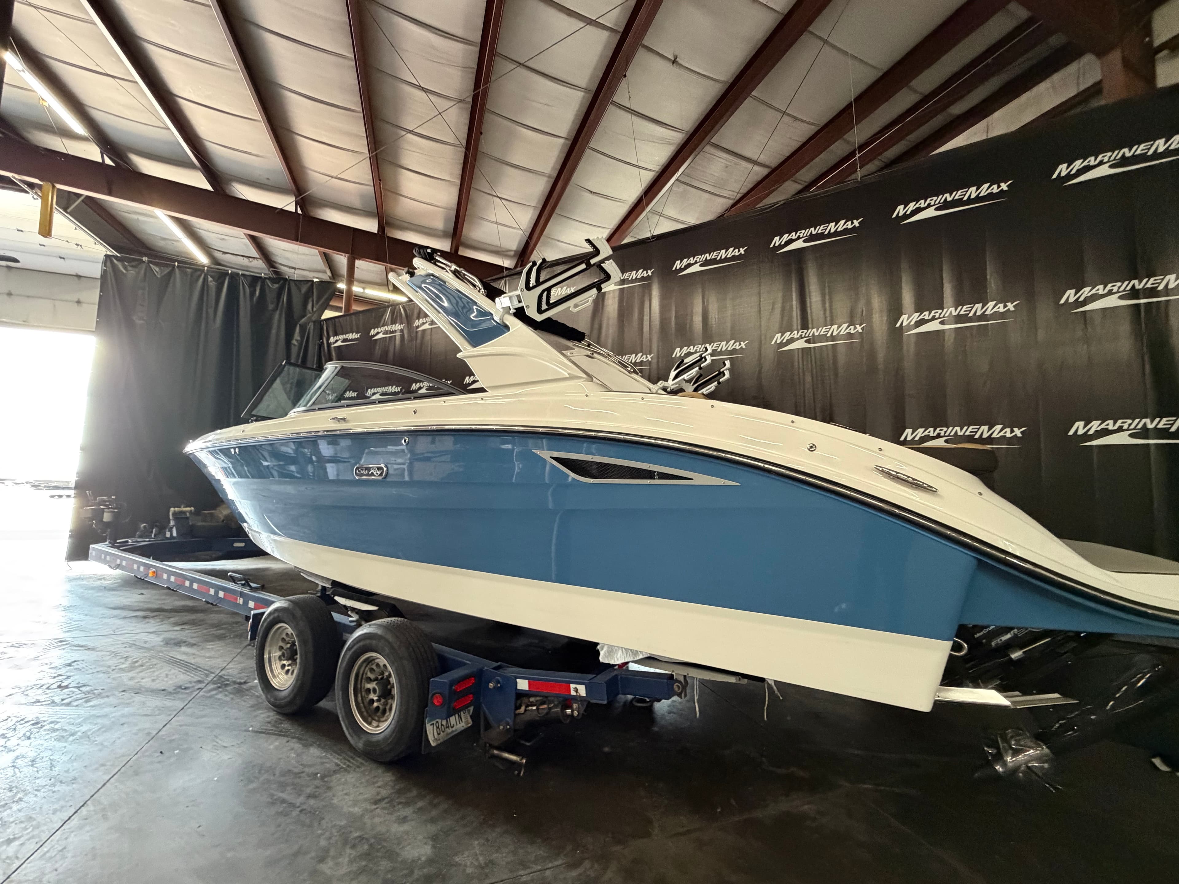 2026 Sea Ray SDX 270 Surf boat in a warehouse on a trailer.