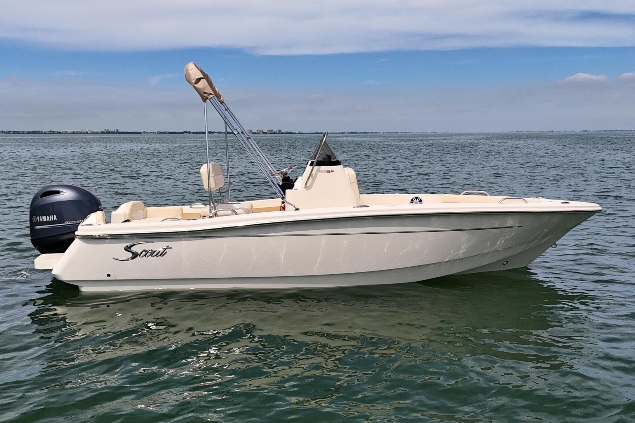 2026 Scout 188 Sportfish boat on calm water with Yamaha outboard motor.