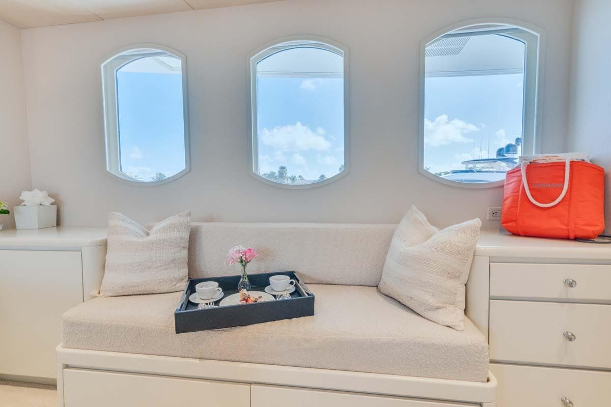 Luxurious 1995 Christensen Tri-Deck yacht interior with cozy seating and elegant decor.