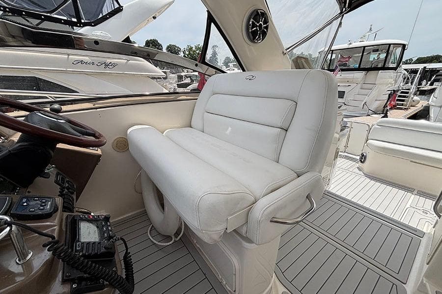 2005 Regal Commodore 4260 yacht interior with white leather seating and control panel.
