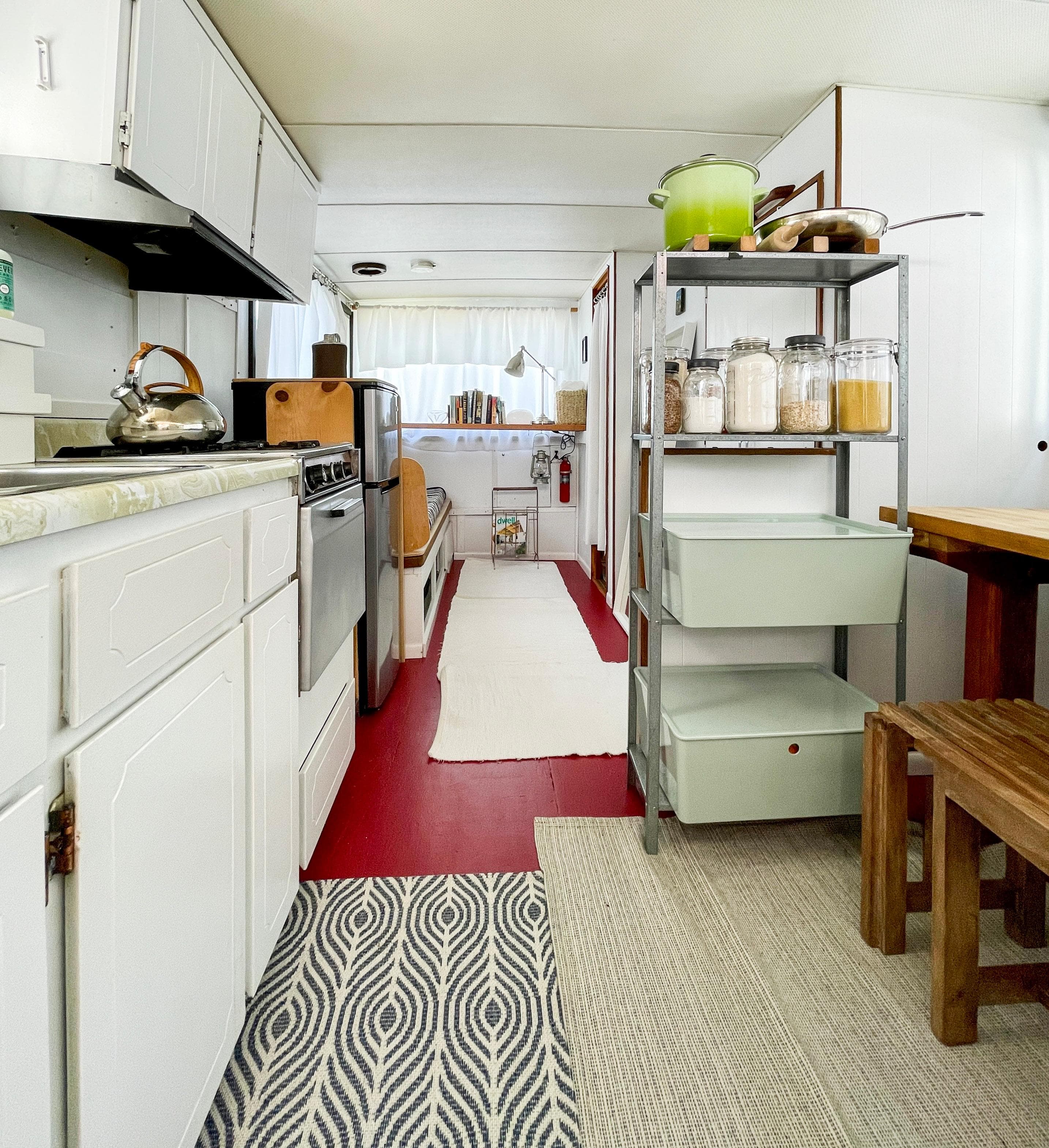 1970 Tollycraft Tollyhome 36 interior with kitchen, shelves, and dining area.