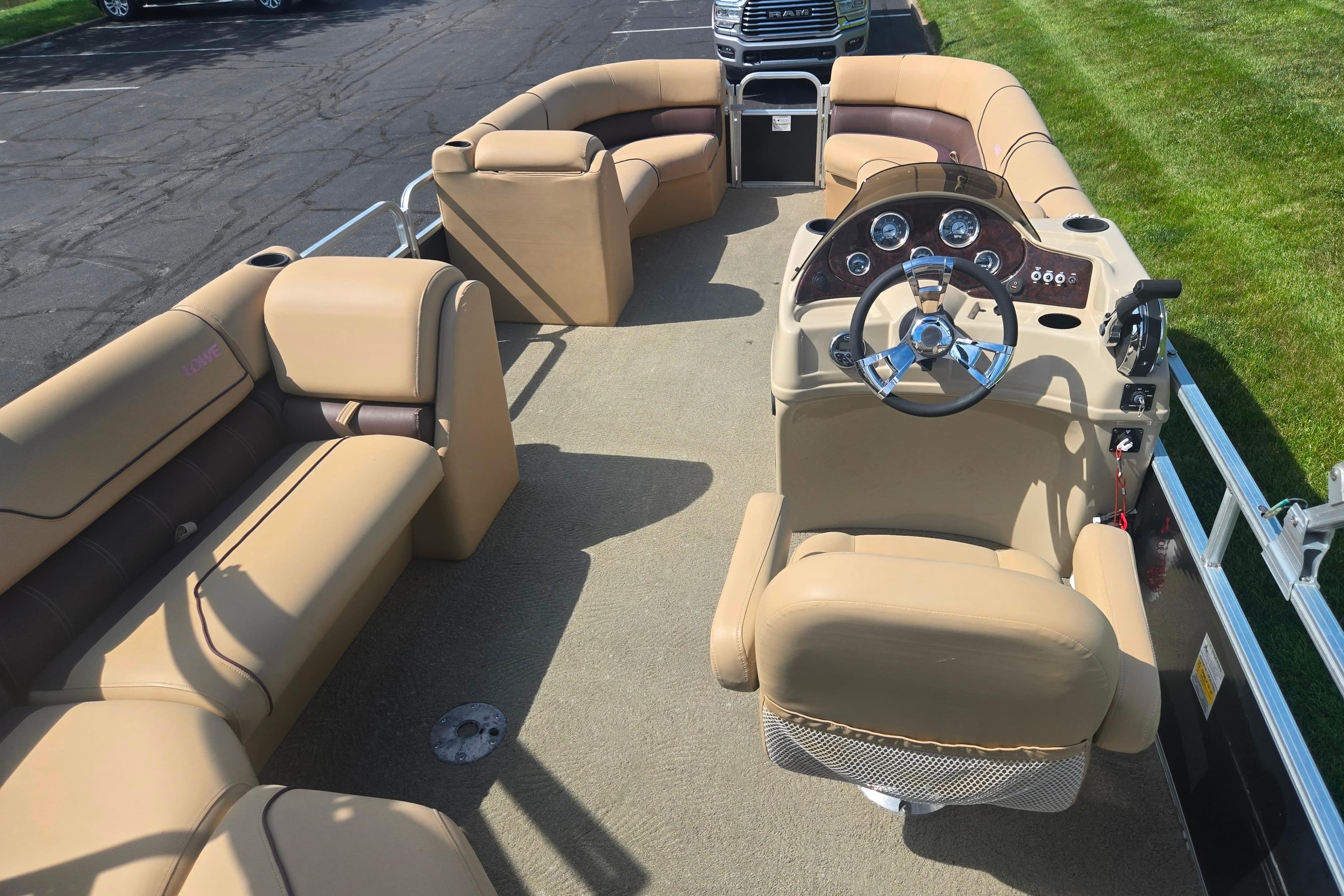 2017 Lowe SS 250 pontoon boat with beige seating and steering console.