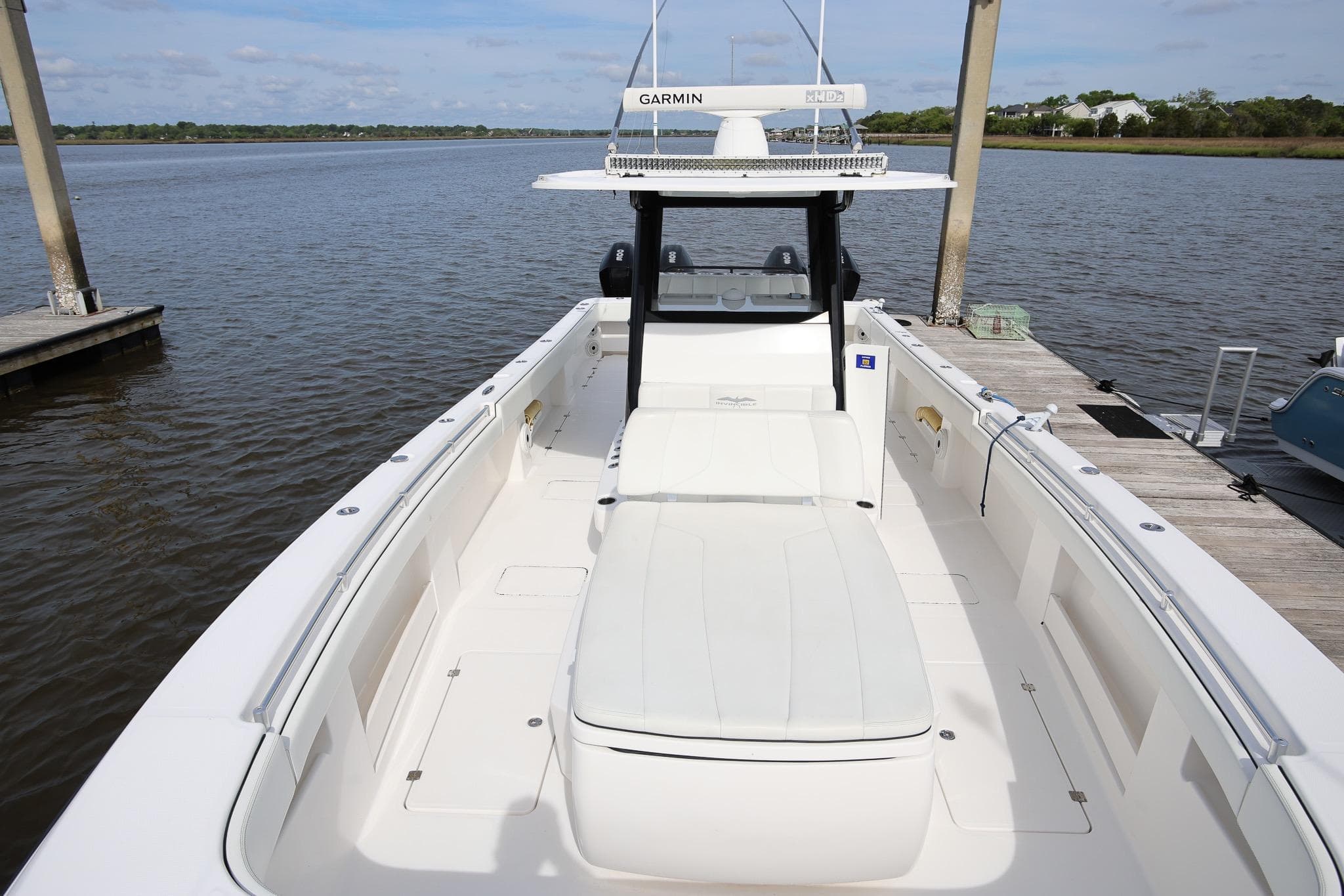 2020 Invincible 35 Catamaran docked, featuring spacious deck and Garmin navigation system.