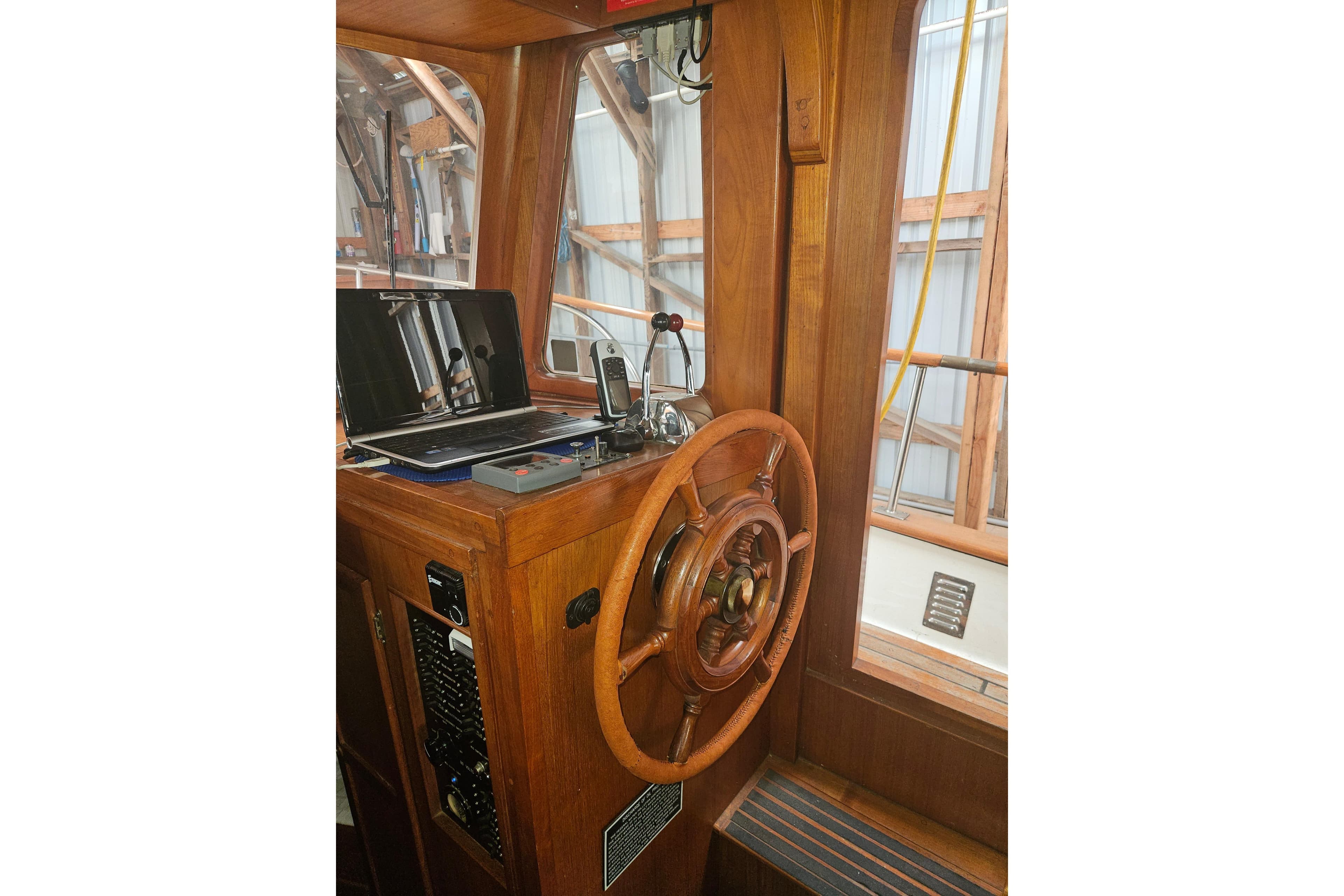 1978 CHB 34 boat helm with wooden steering wheel and navigation equipment.