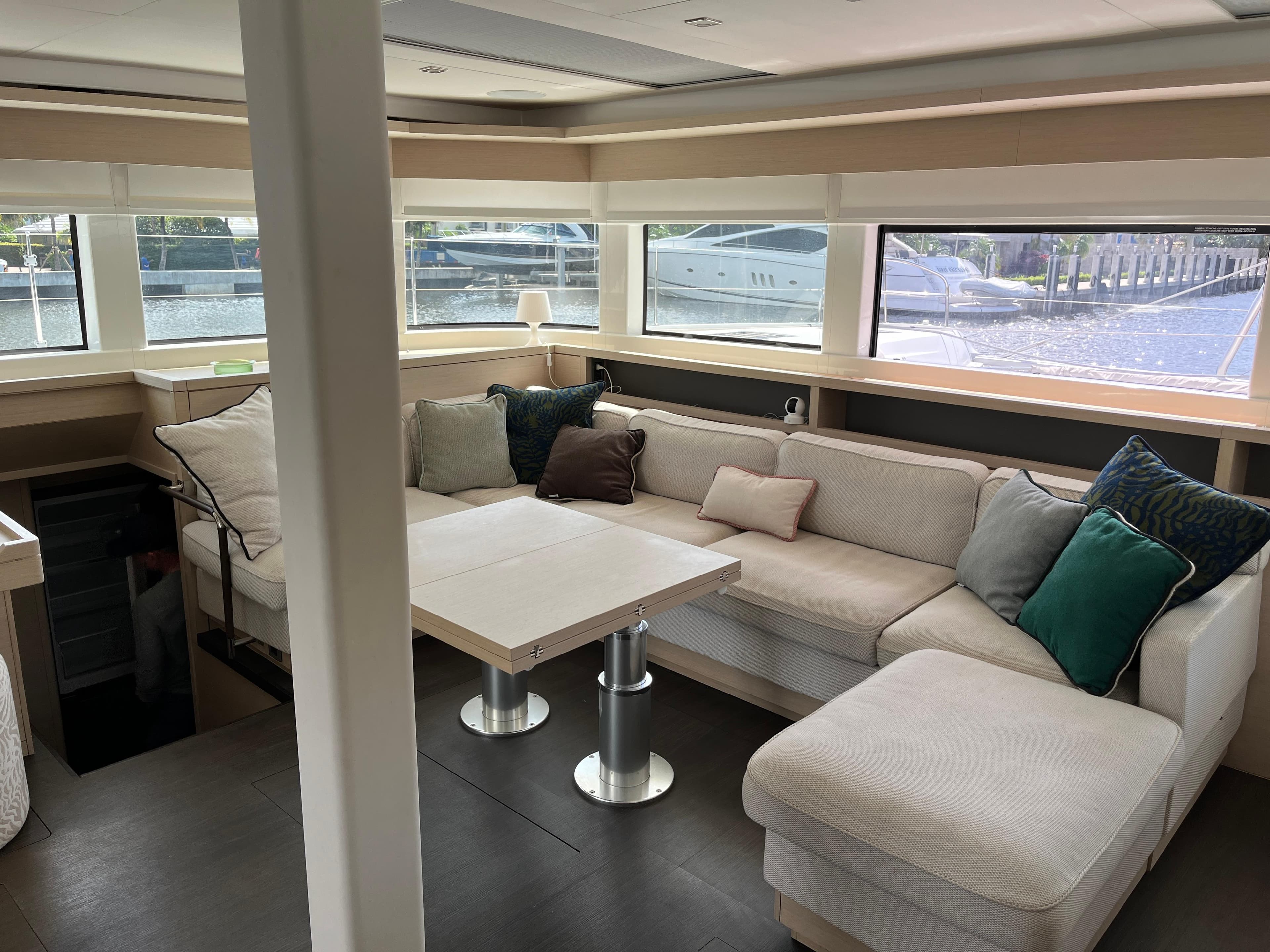 Luxurious interior of 2021 Lagoon 55 yacht with spacious seating and large windows.