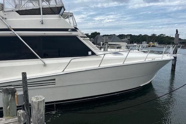1988 Viking 45 Convertible yacht docked at marina, side view.
